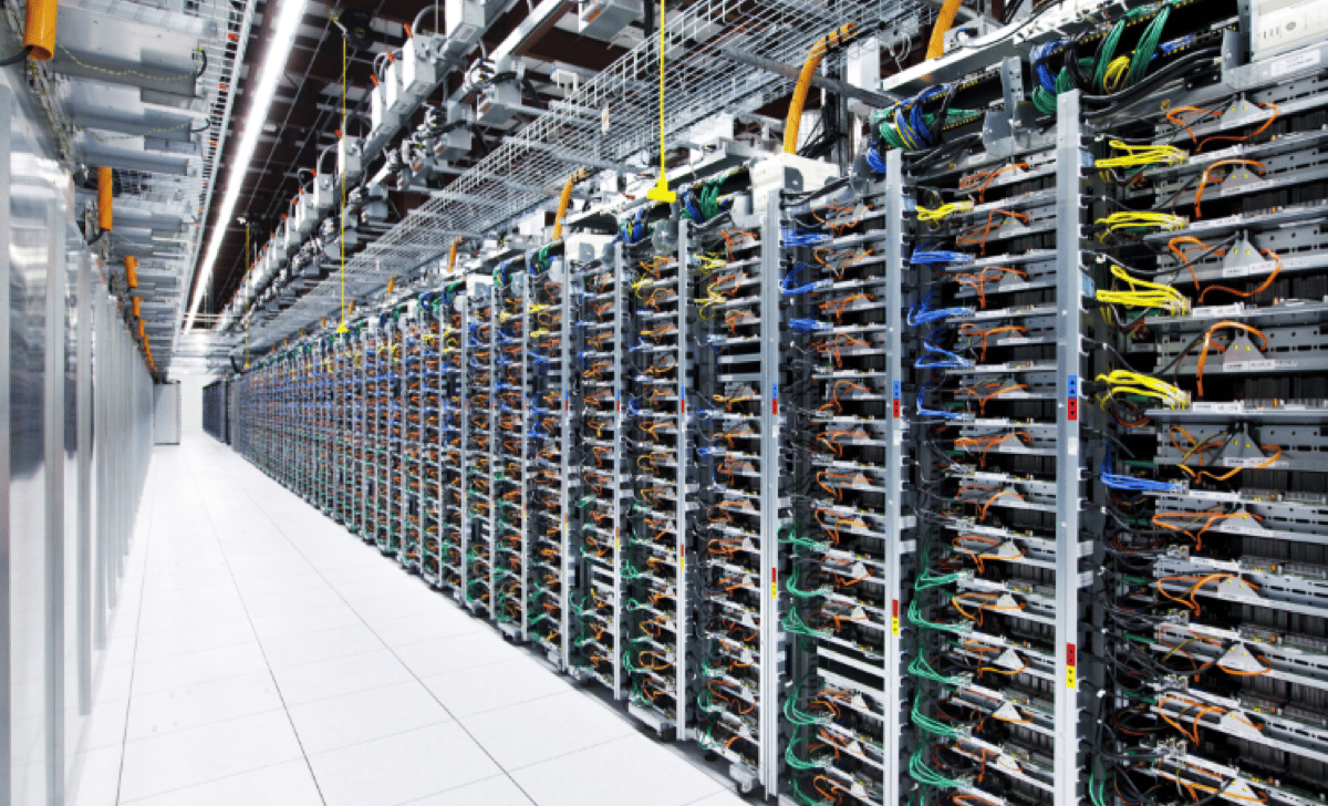 Inside a real data center showing rows of server racks with network cabling