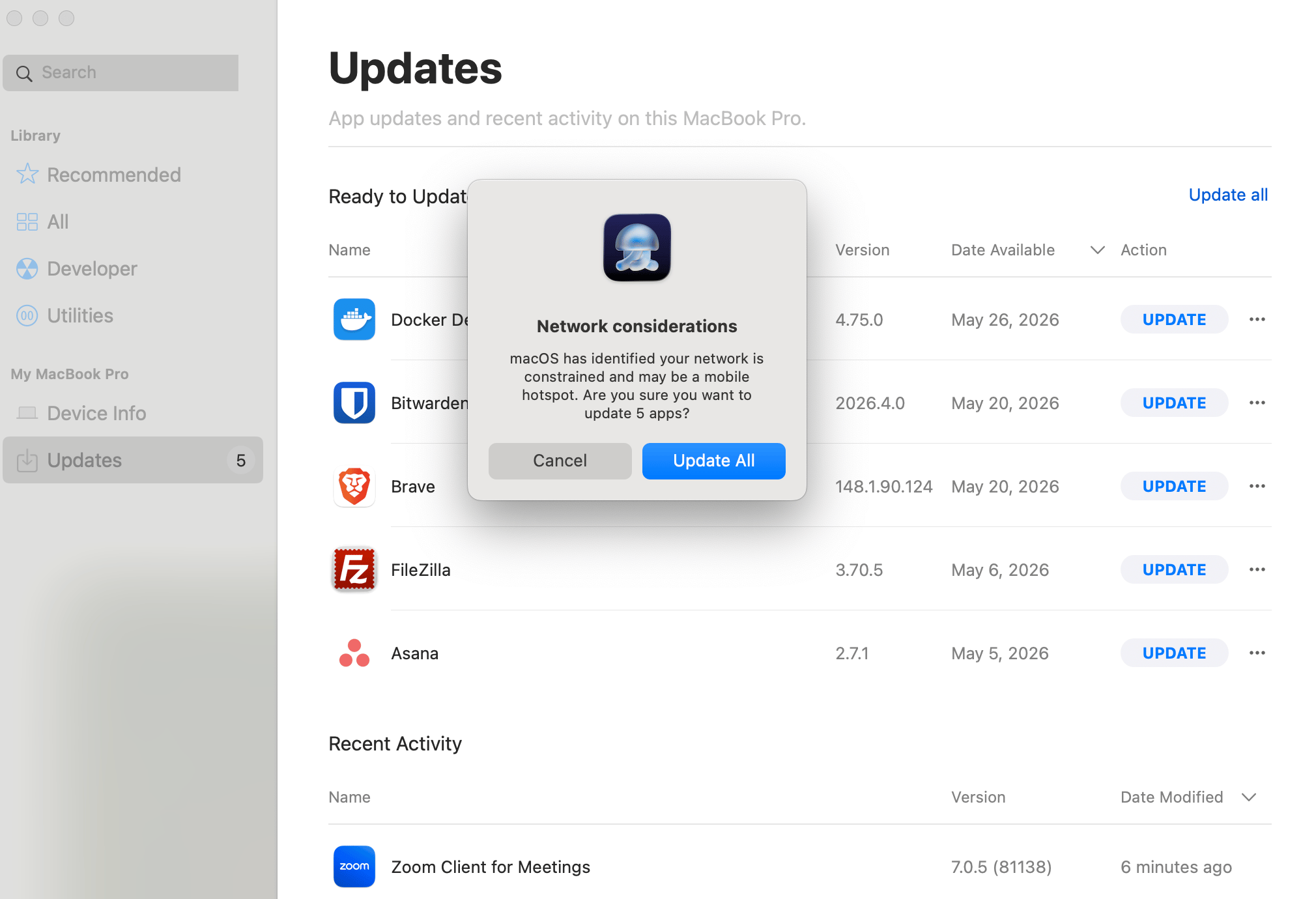 Iru Self Service Updates view with Network considerations dialog warning that macOS identified a constrained network or mobile hotspot before updating apps