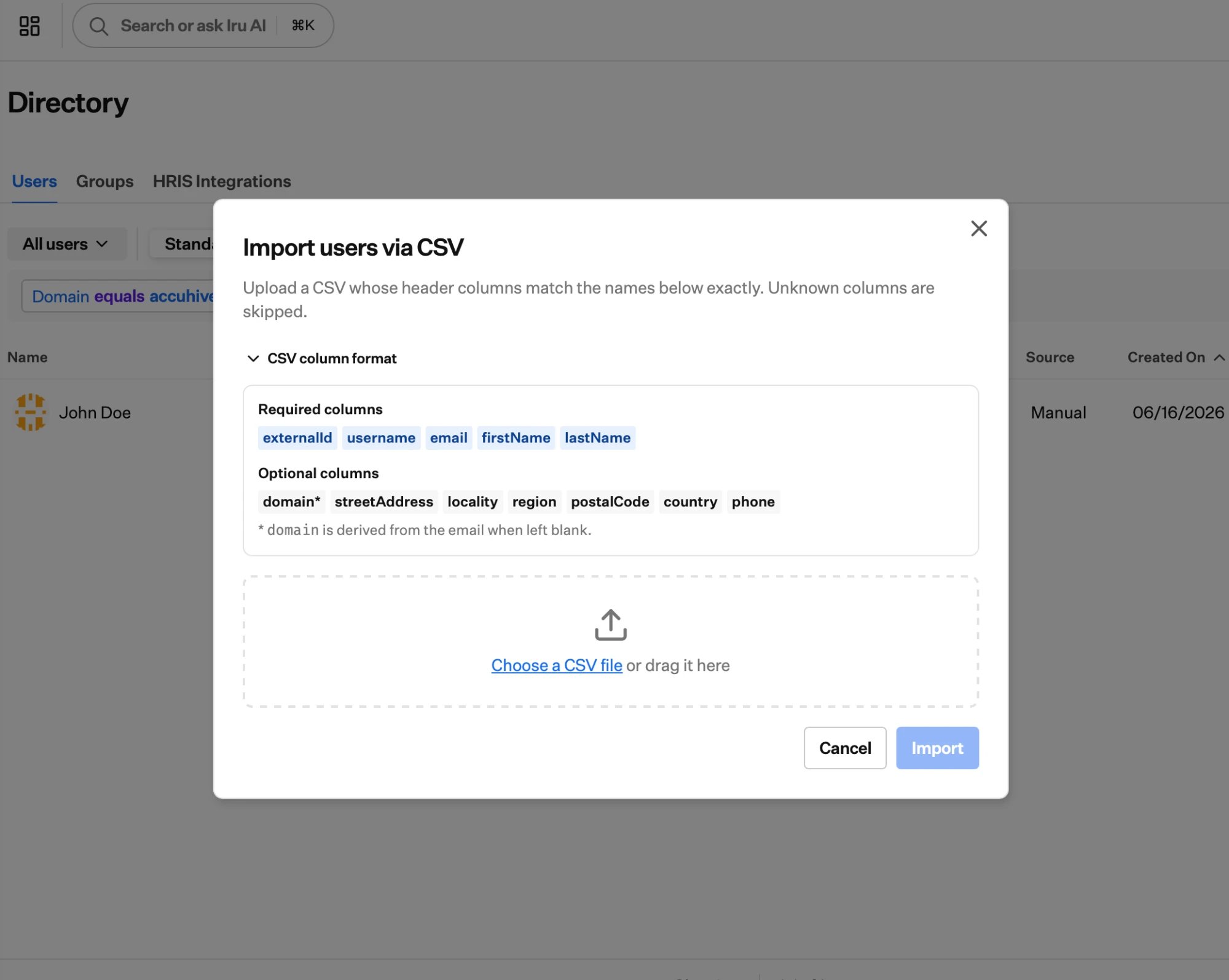 The Import users via CSV dialog listing required columns externalId, username, email, firstName, lastName and optional columns domain, streetAddress, locality, region, postalCode, country, phone, with an area to choose or drag a CSV file.