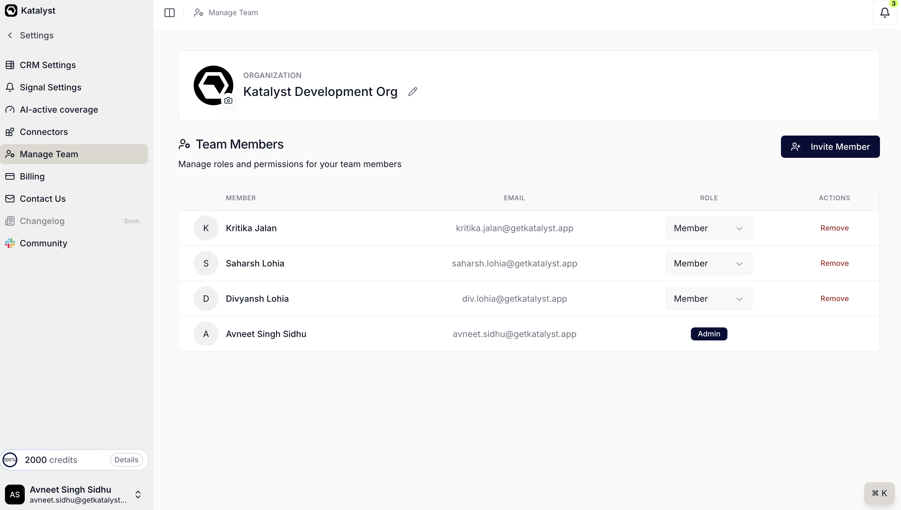 The Manage Team page showing an organization card with the org name and logo, and a Team Members table listing each member's name, email, an inline Role select, and a Remove action, with an Invite Member button above it and the admin marked with an Admin badge.