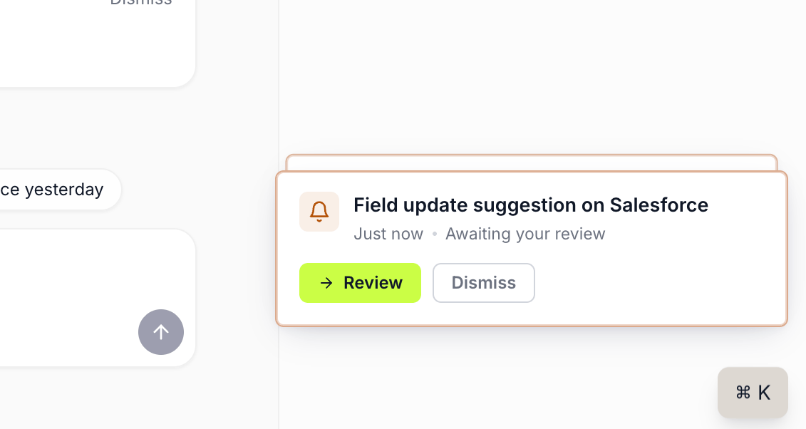 A toast notification anchored in the bottom-right corner of a Katalyst page, warning-bordered and titled Field update suggestion on Salesforce with an awaiting-your-review sub-line, carrying Review and Dismiss chips, with a second toast card stacked behind it.