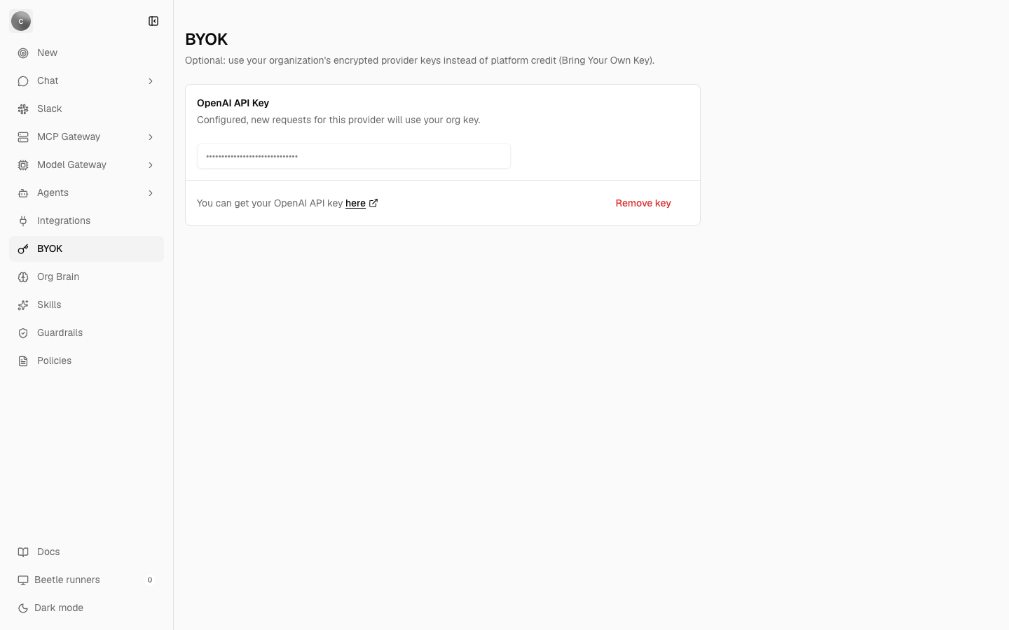 The BYOK page showing one card titled OpenAI API Key, the description 'Configured, new requests for this provider will use your org key.', a masked disabled input, a 'You can get your OpenAI API key here' link and a Remove key action.