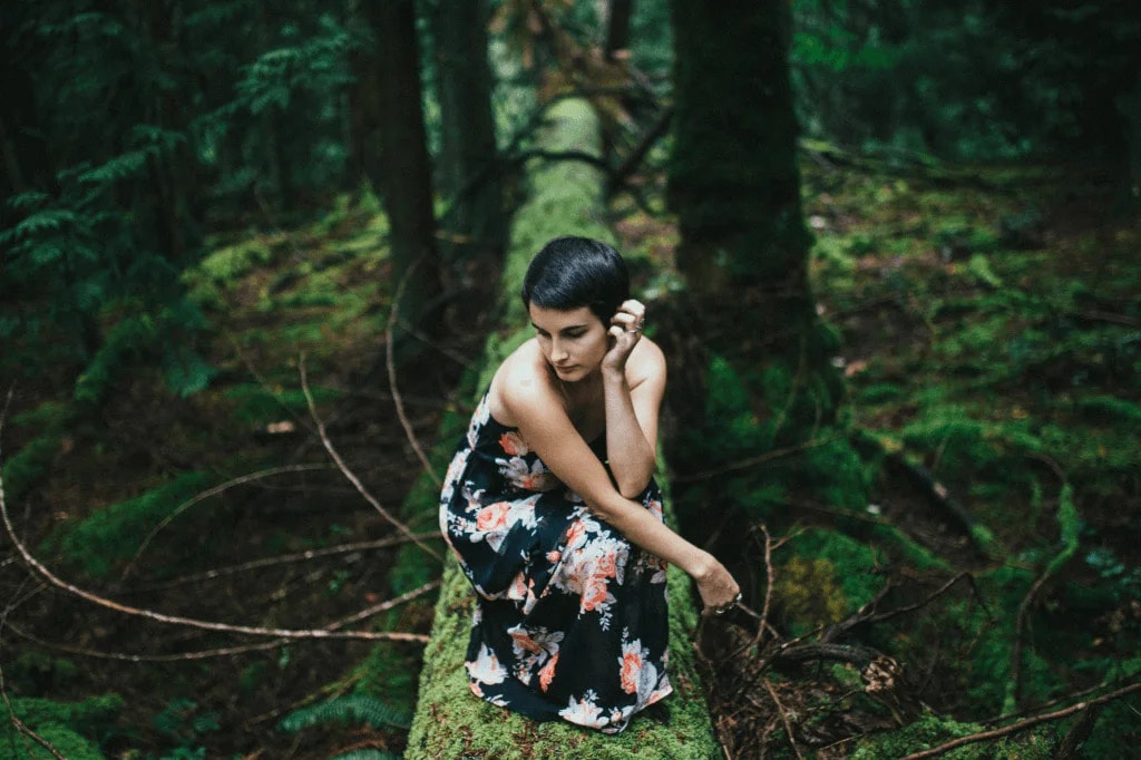 Portrait Of Woman On A Tree Trunk Web