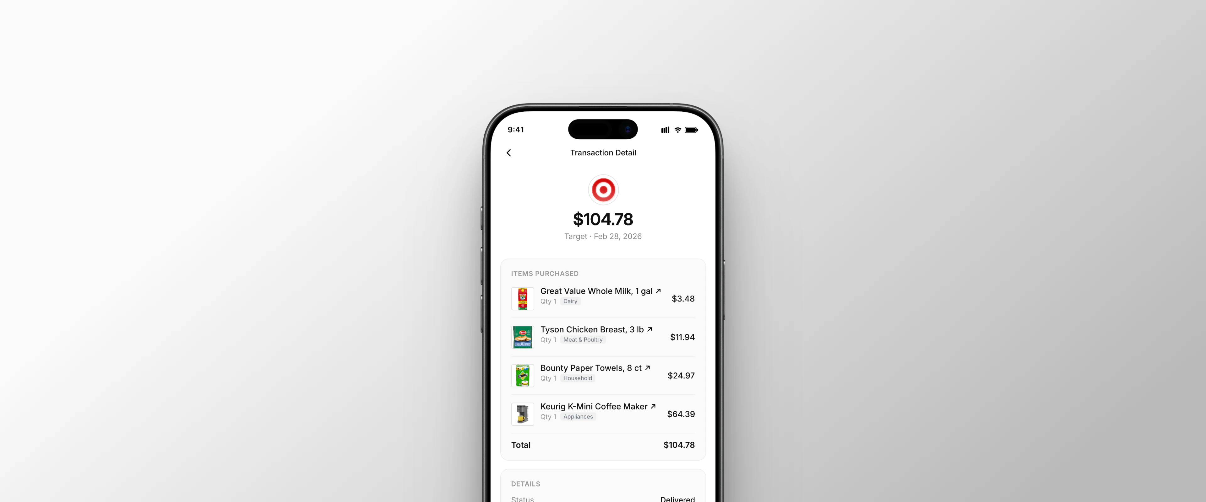 Transaction detail screen showing a $104.78 Target order with itemized products including milk, chicken, paper towels, and a coffee maker