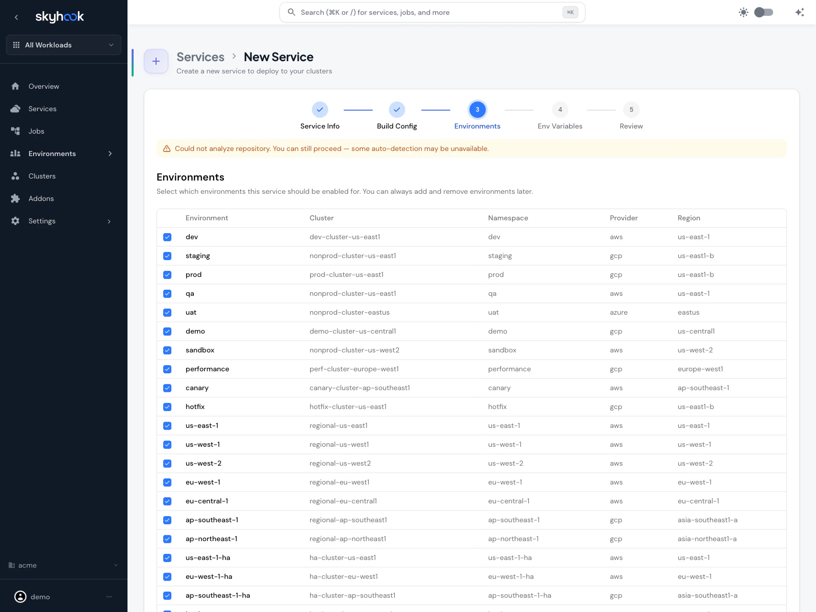 Environments step showing a table with environment name, cluster, namespace, provider, and region columns, with checkboxes on each row for dev, prod, staging, customer envs, and per-customer rows