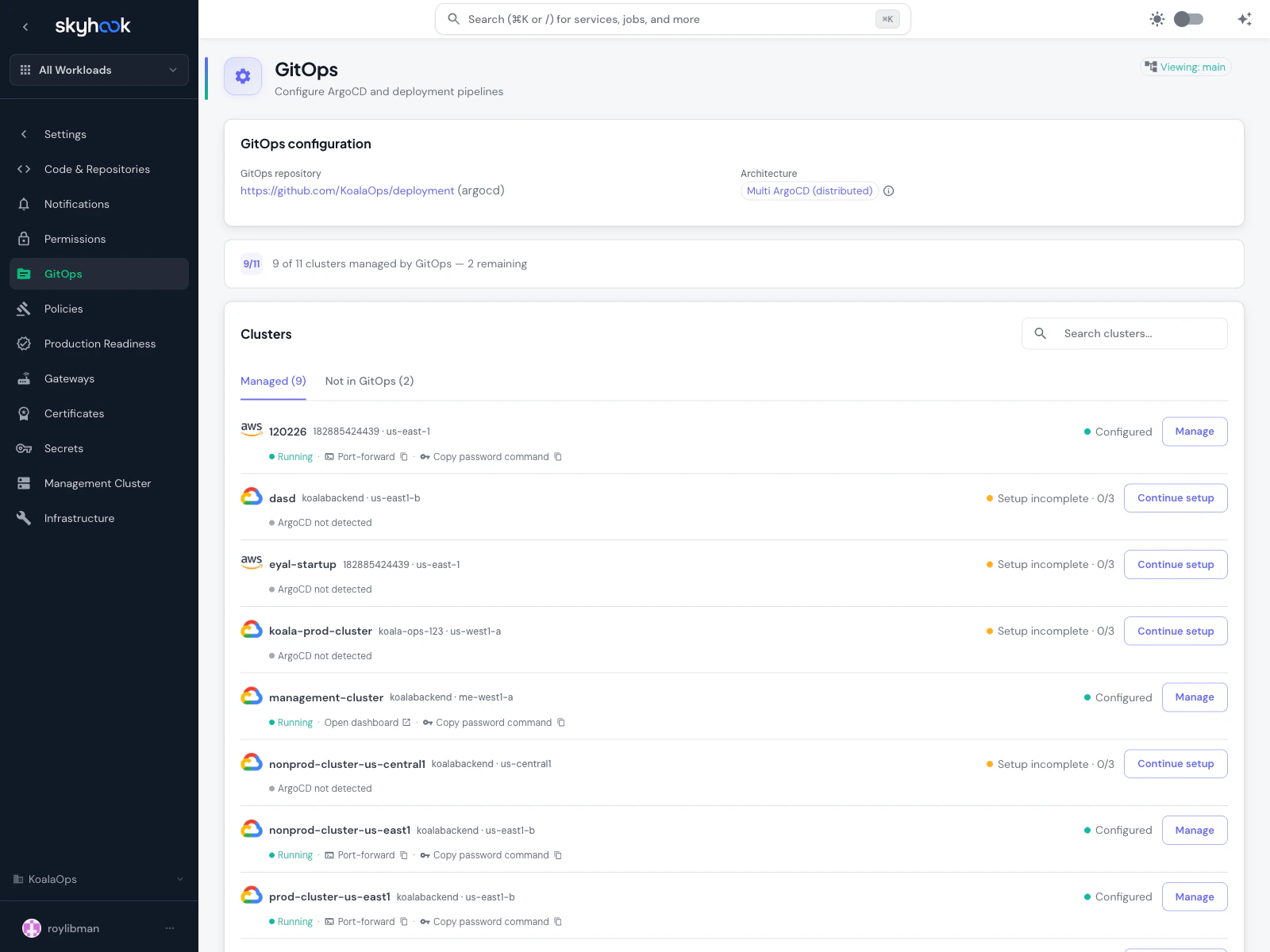GitOps overview page showing the configured GitOps repository (KoalaOps/deployment), a 9/11 clusters managed progress indicator, and a Clusters table with Managed and Not in GitOps tabs. Rows show a mix of Configured clusters with Manage buttons and Setup incomplete clusters with Continue setup buttons