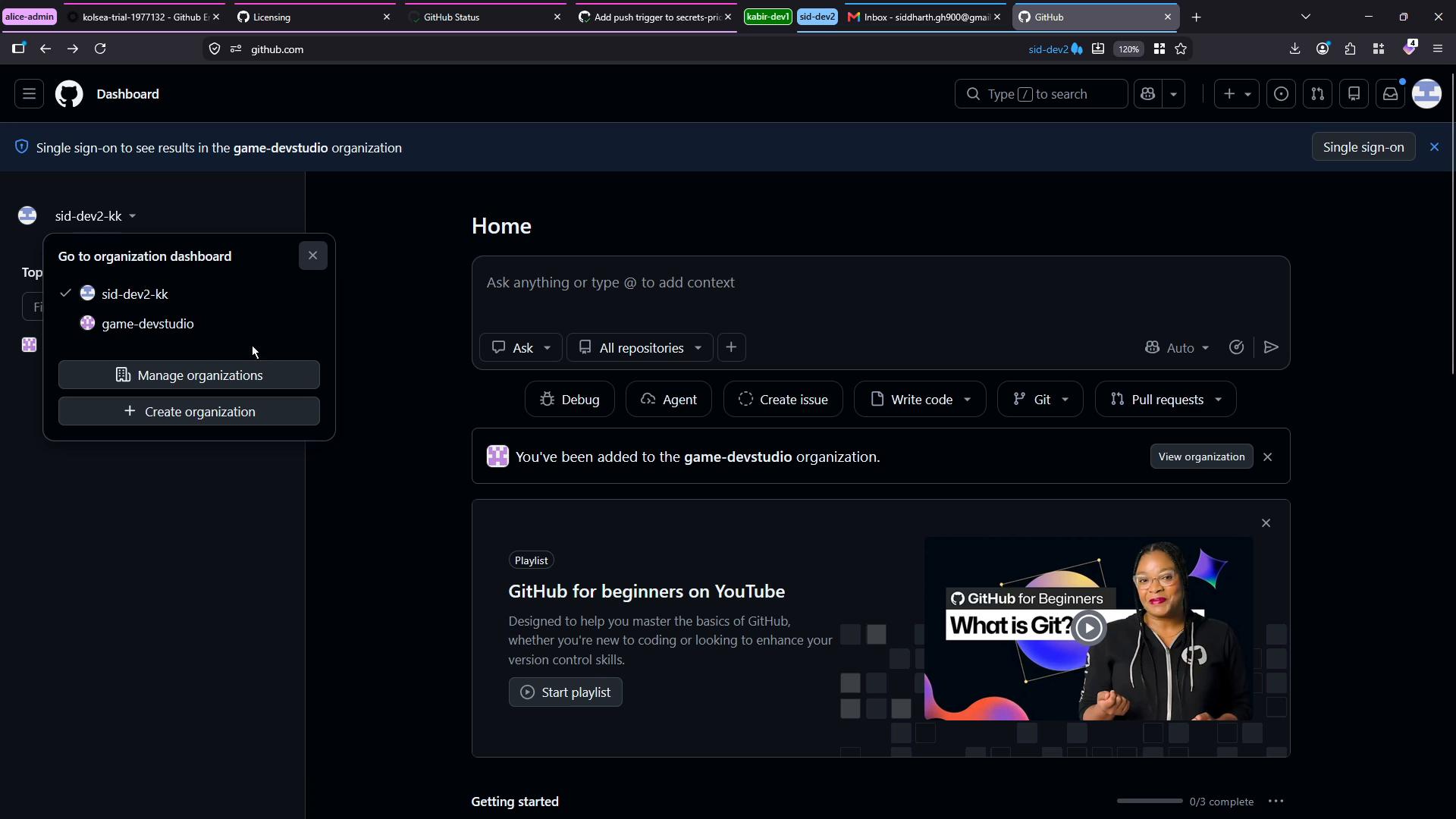 A dark-mode GitHub dashboard screenshot showing the Home page with an organization switcher dropdown open (sid-dev2-kk and game-devstudio) and action buttons like Create issue, Write code, and Pull requests. A "GitHub for beginners" playlist card with a video thumbnail appears lower on the page.