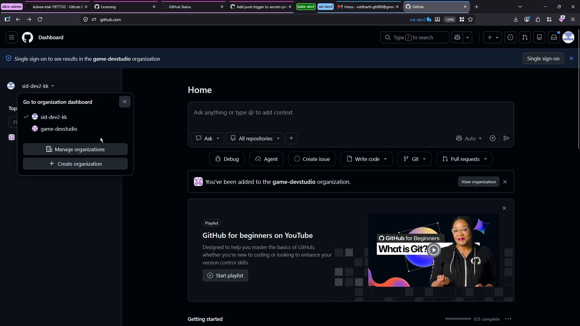 A dark-mode GitHub dashboard screenshot showing the Home page with an organization switcher dropdown open (sid-dev2-kk and game-devstudio) and action buttons like Create issue, Write code, and Pull requests. A "GitHub for beginners" playlist card with a video thumbnail appears lower on the page.