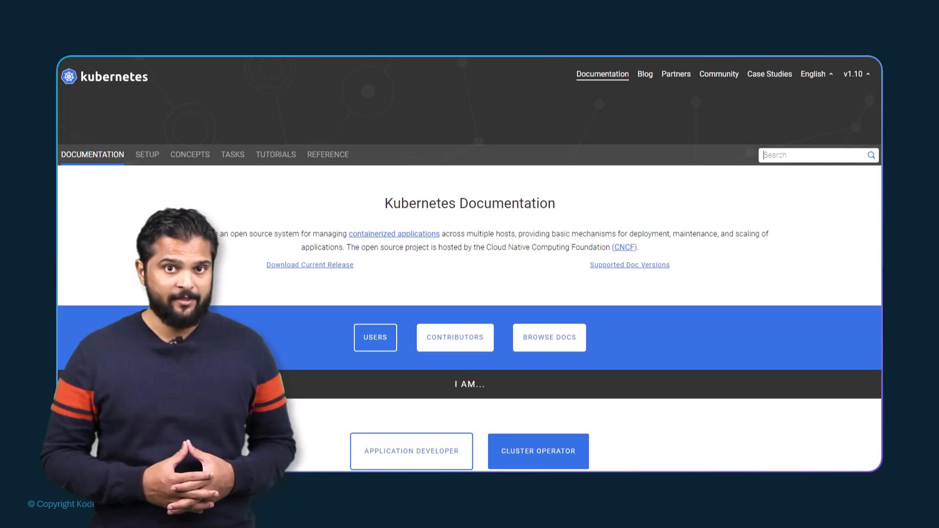 A presenter stands in front of a large screen showing the Kubernetes Documentation webpage. The page header and "Kubernetes Documentation" title are clearly visible behind him.