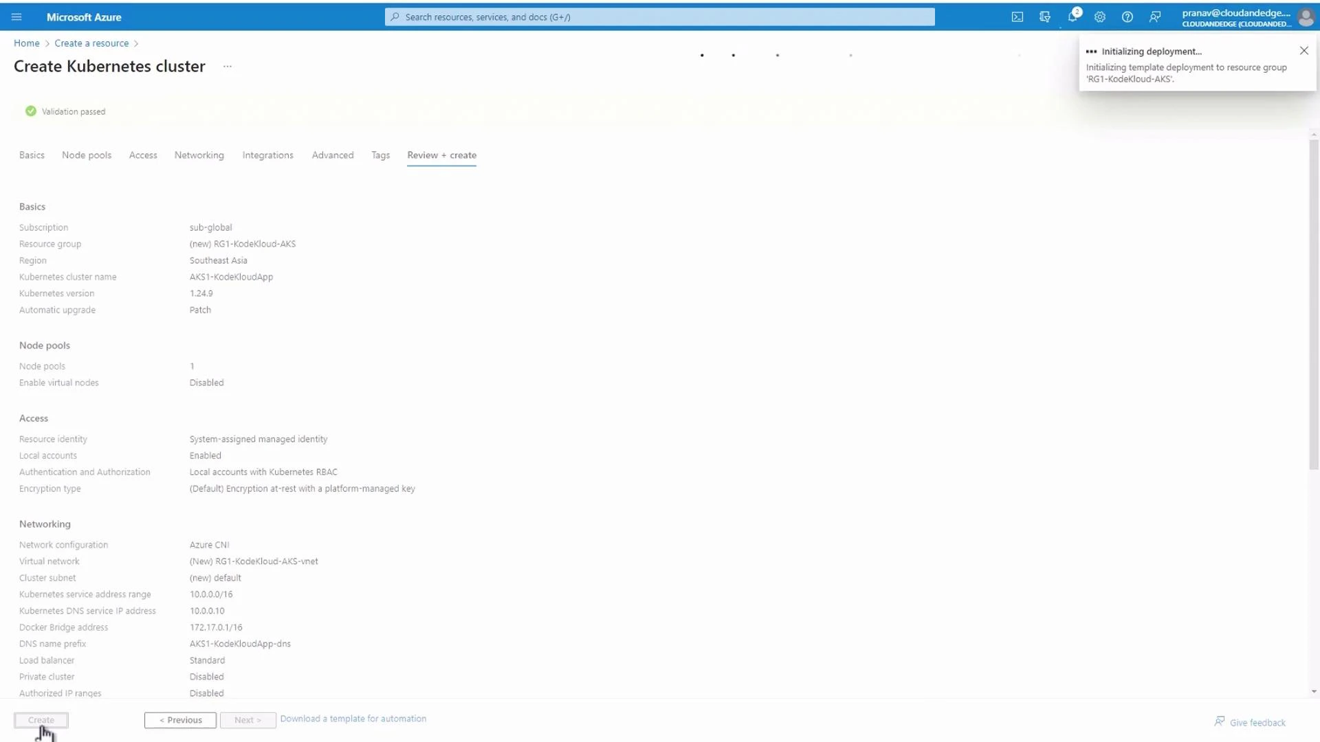 A screenshot of the Microsoft Azure portal showing the "Create Kubernetes cluster" Review + create page with validation passed and cluster settings (region, resource group, networking, node pools) displayed. A notification in the top-right shows "Initializing deployment..." for the resource group.