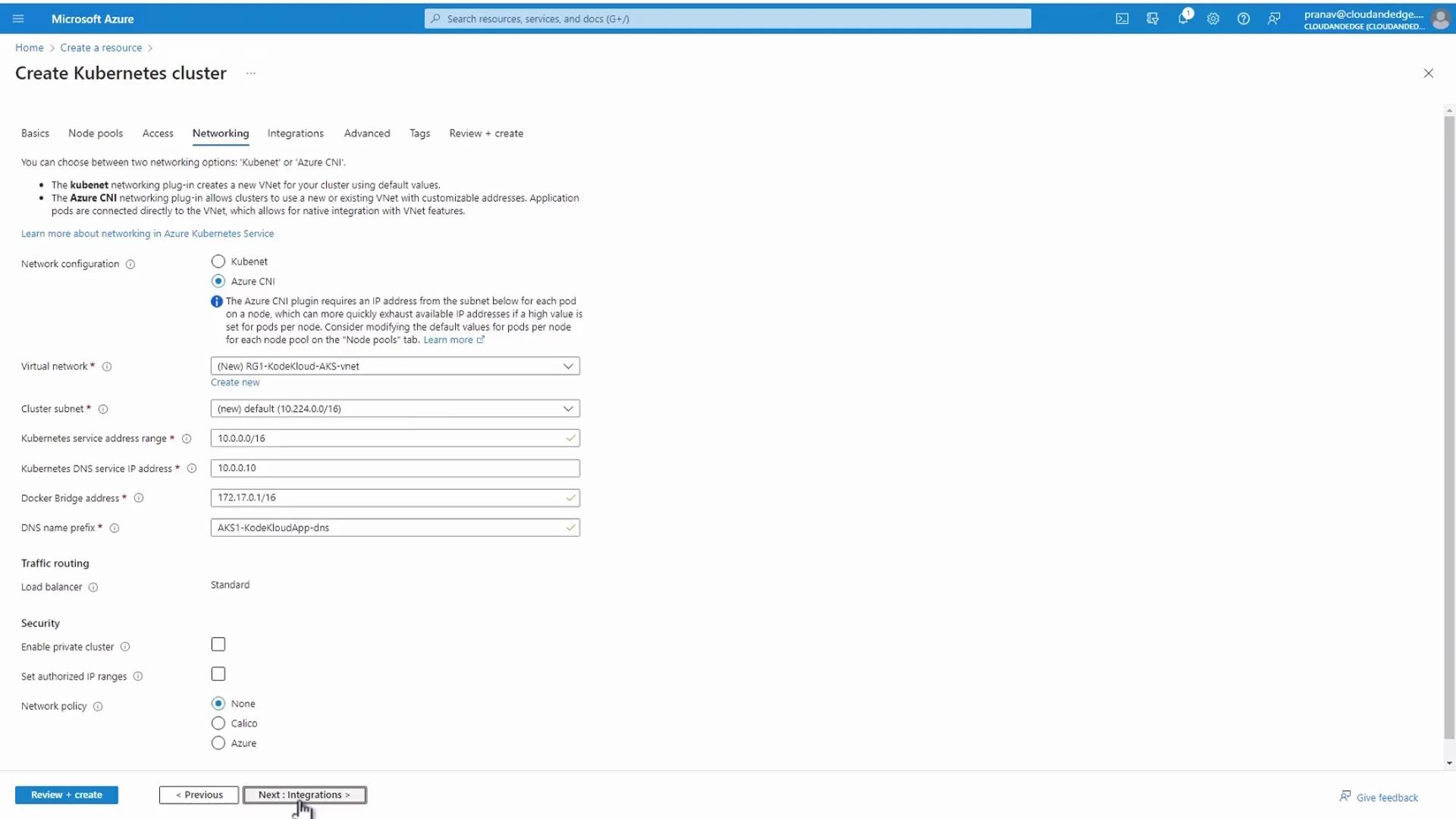 A screenshot of the Microsoft Azure portal showing the "Create Kubernetes cluster" wizard on the Networking tab, with fields for network configuration, virtual network, cluster subnet, service/DNS addresses, Docker bridge, and network policy. Navigation buttons like "Review + create" and "Next: Integrations" are visible at the bottom.