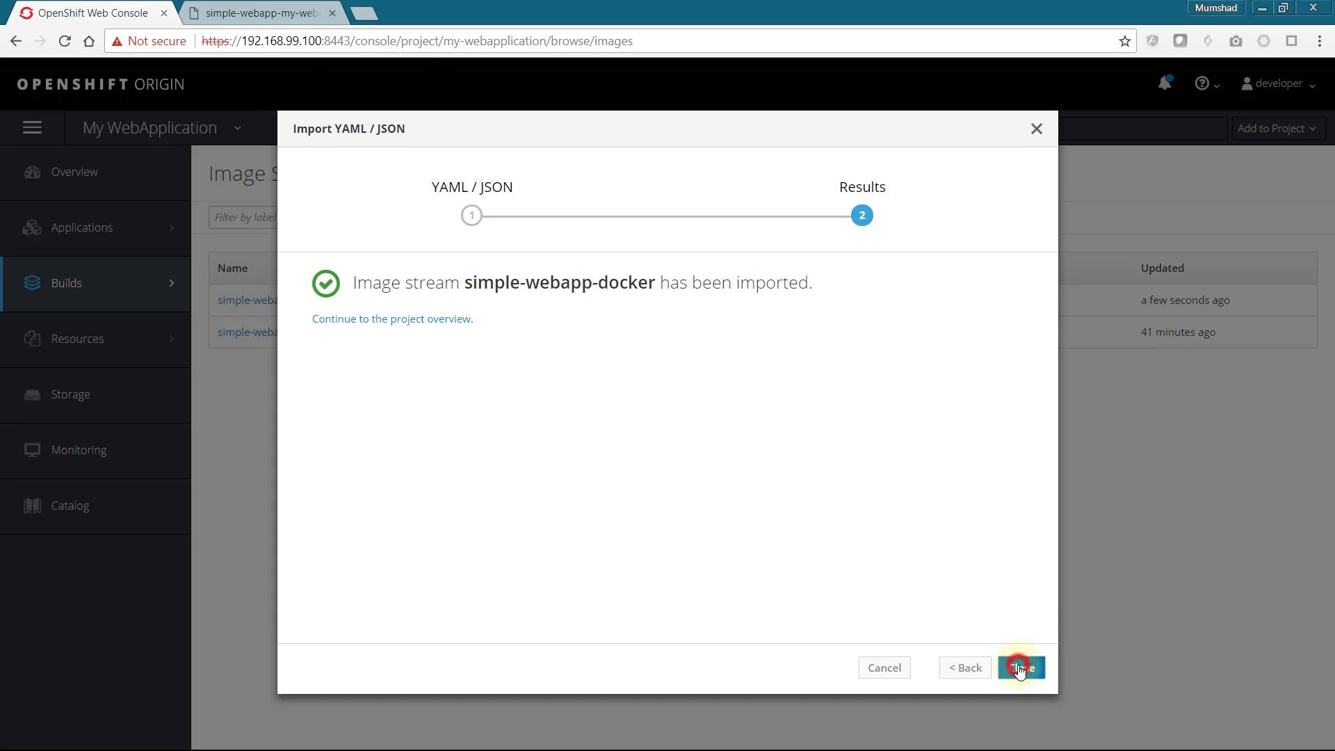 A screenshot of the OpenShift Origin web console showing a modal dialog that says "Image stream simple-webapp-docker has been imported." The dialog displays import results and a link to continue to the project overview.