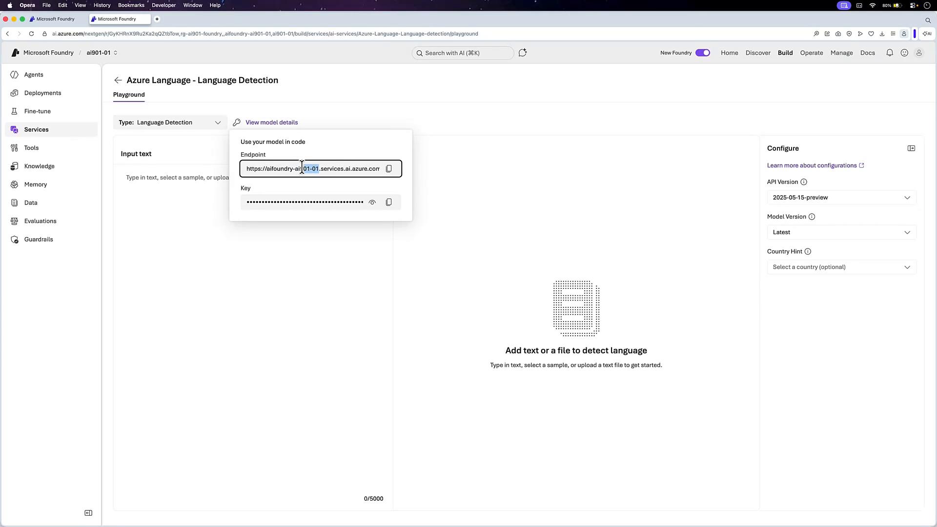 A screenshot of the Microsoft Foundry/Azure web interface showing the "Azure Language - Language Detection" playground. A modal overlays the page displaying an endpoint URL and a concealed API key, with configuration options and a large area to add text for language detection.