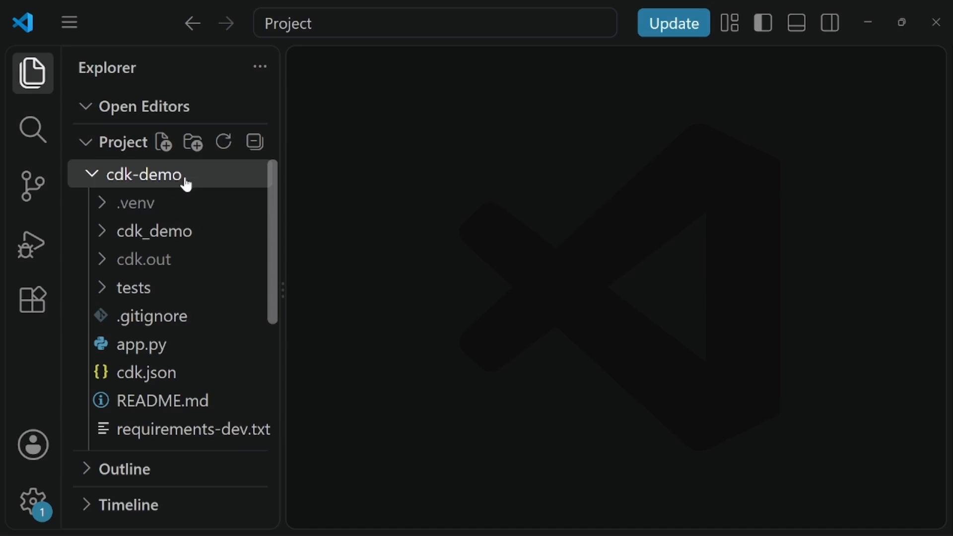 A dark-themed Visual Studio Code window showing the Explorer sidebar with a project folder named "cdk-demo" and files like app.py, cdk.json, README.md and requirements-dev.txt. The main editor area is empty, displaying a faint VS Code logo.