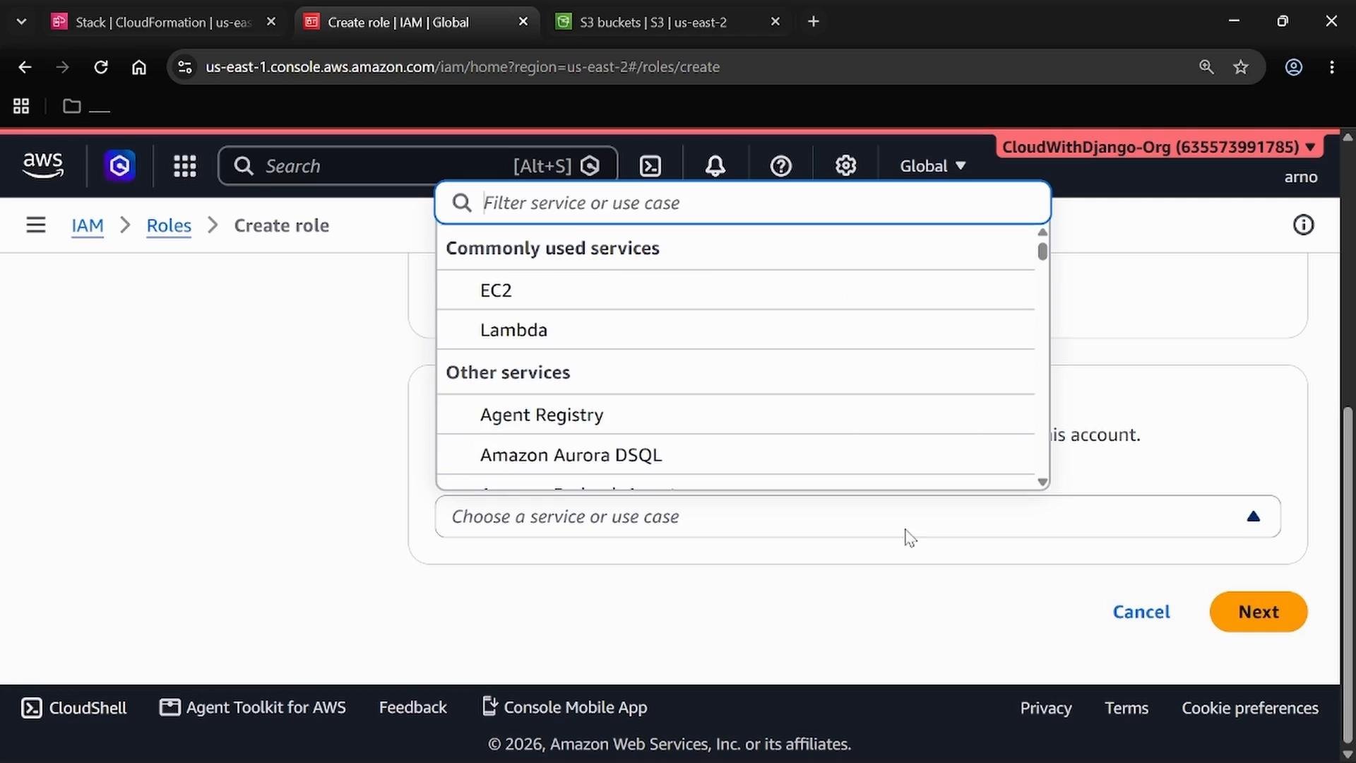 A screenshot of the AWS Management Console on the IAM "Create role" page showing a service selection dropdown listing commonly used services like EC2 and Lambda. The page footer shows Cancel and Next buttons for proceeding.
