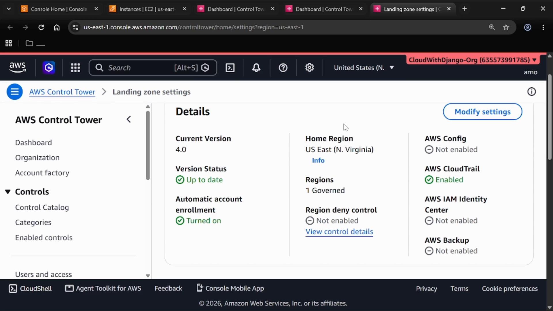 A screenshot of the AWS Management Console showing the AWS Control Tower "Landing zone settings" page, with a Details panel listing current version, home region (US East N. Virginia), and service enablement statuses like AWS CloudTrail. The left sidebar displays Control Tower navigation items such as Dashboard, Organization, and Controls.