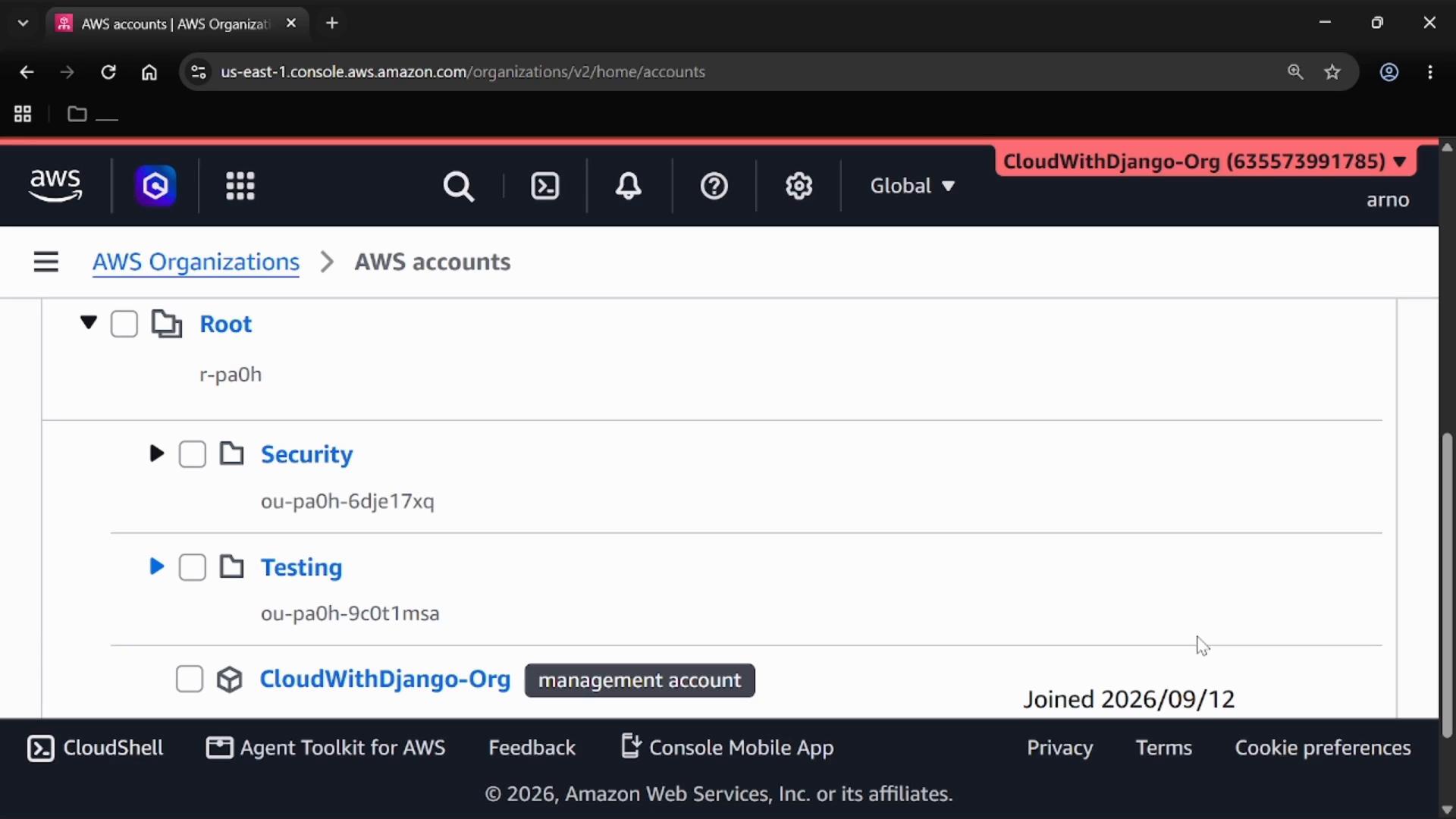 A screenshot of the AWS Organizations console showing a hierarchy of organizational units (Root, Security, Testing) and a management account entry. The top navigation and CloudShell/footer are also visible.