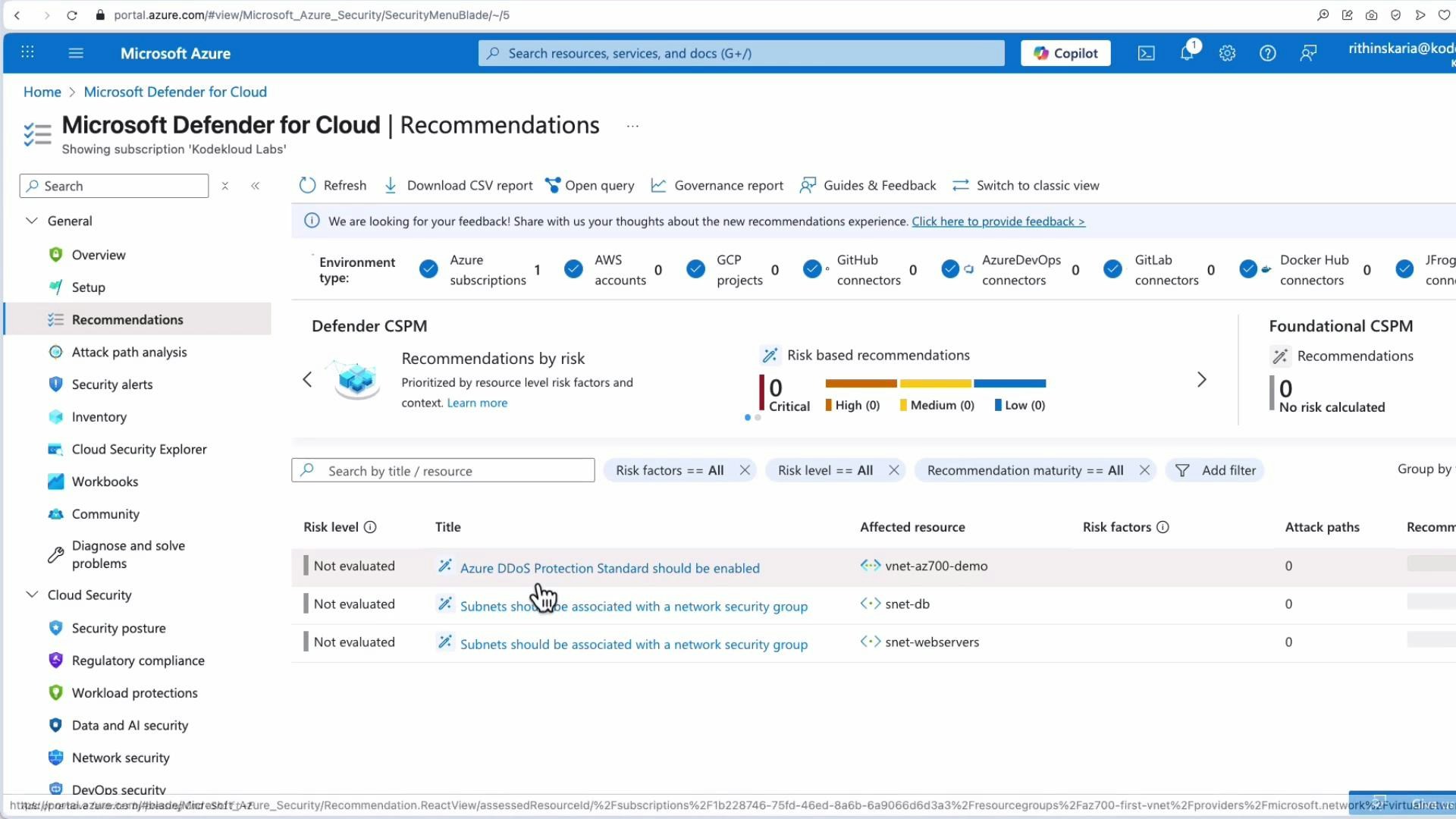 A screenshot of the Microsoft Azure portal showing the Microsoft Defender for Cloud "Recommendations" dashboard. It lists security recommendations (e.g., enable Azure DDoS Protection Standard, associate subnets with network security groups) along with risk summary widgets.