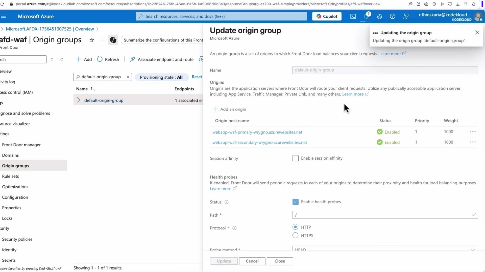 A screenshot of the Microsoft Azure portal showing the "Update origin group" dialog for an Azure Front Door profile, listing two origin hosts (primary and secondary webapps) with health probes enabled. The left navigation pane highlights "Origin groups" within the Front Door resource.