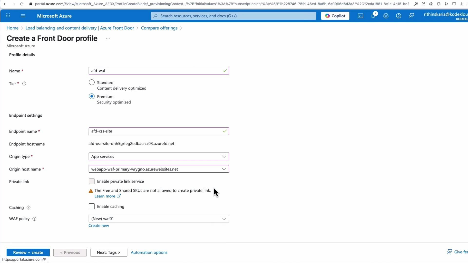 A screenshot of the Microsoft Azure portal showing the "Create a Front Door profile" form with Profile details and Endpoint settings. The Premium tier is selected and fields visible include endpoint name/hostname, origin type (App services), origin host name, private link option, caching, and a WAF policy.