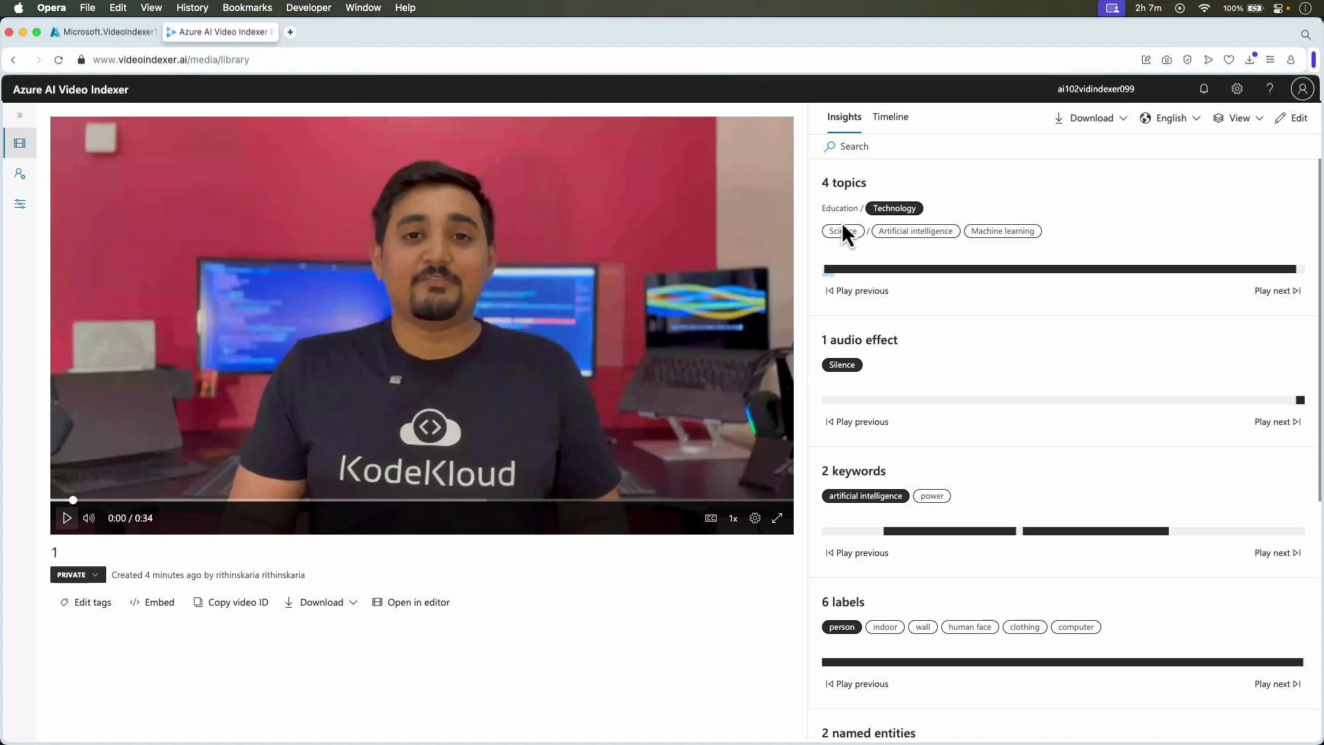 A man wearing a "KodeKloud" t-shirt sits facing the camera with computer monitors behind him. The image is shown inside a browser window displaying the Azure AI Video Indexer interface and video insights on the right.