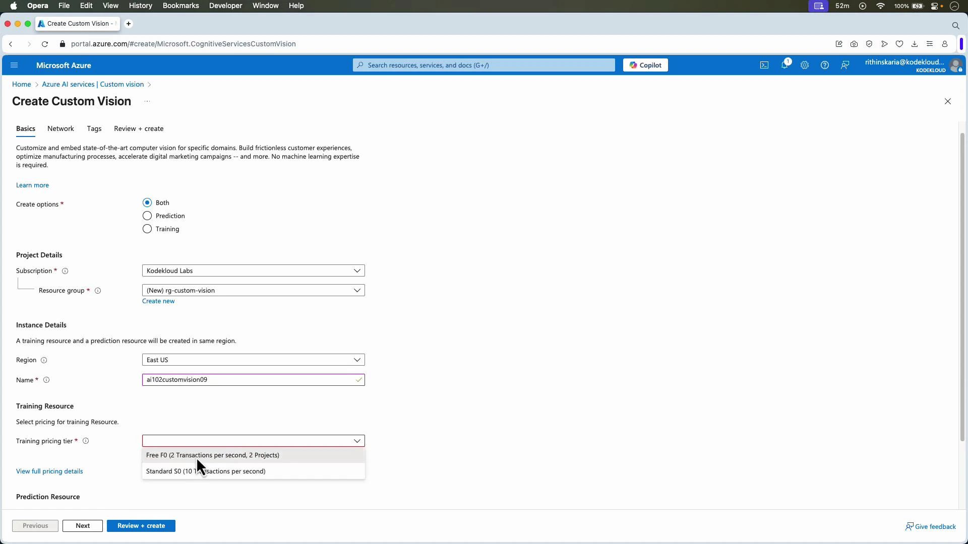 A screenshot of the Microsoft Azure portal showing the "Create Custom Vision" page with form fields for project and instance details (subscription, resource group, region, name) and a training pricing-tier dropdown. The bottom shows navigation buttons like Previous, Next, and Review + create.