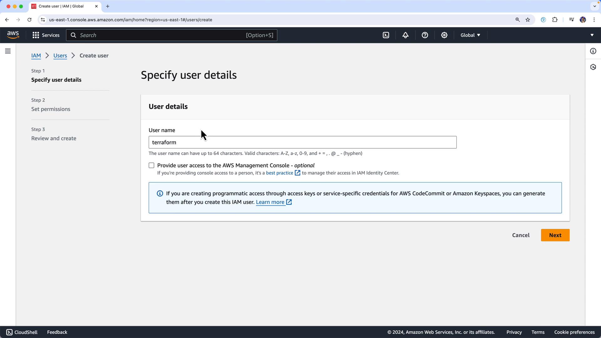 A screenshot of the AWS IAM "Create user" console on the "Specify user details" step, with the username field filled as "terraform." The page shows options for providing console access and a note about generating programmatic access keys, with Cancel and Next buttons at the bottom.