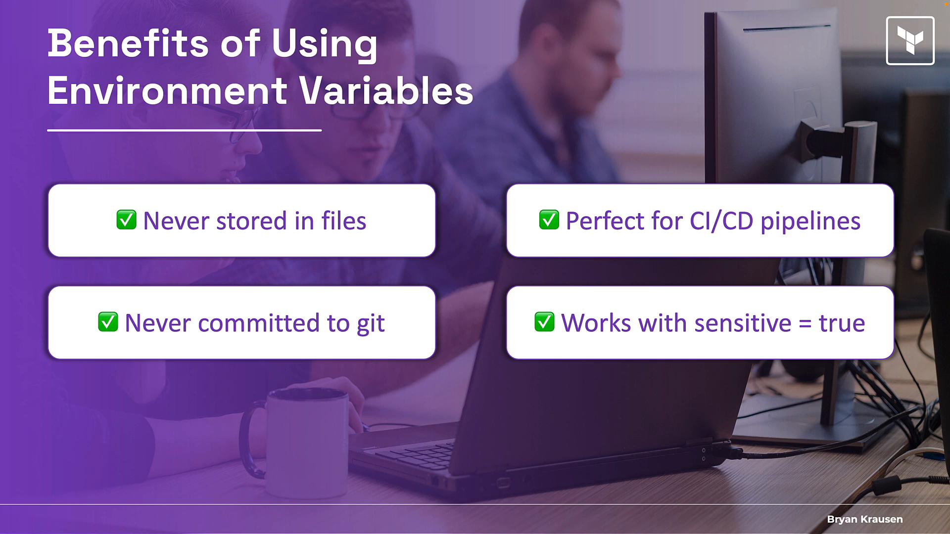 A presentation slide titled "Benefits of Using Environment Variables" showing four callouts: "Never stored in files," "Never committed to git," "Perfect for CI/CD pipelines," and "Works with sensitive = true." The background shows people working at laptops and monitors in an office.