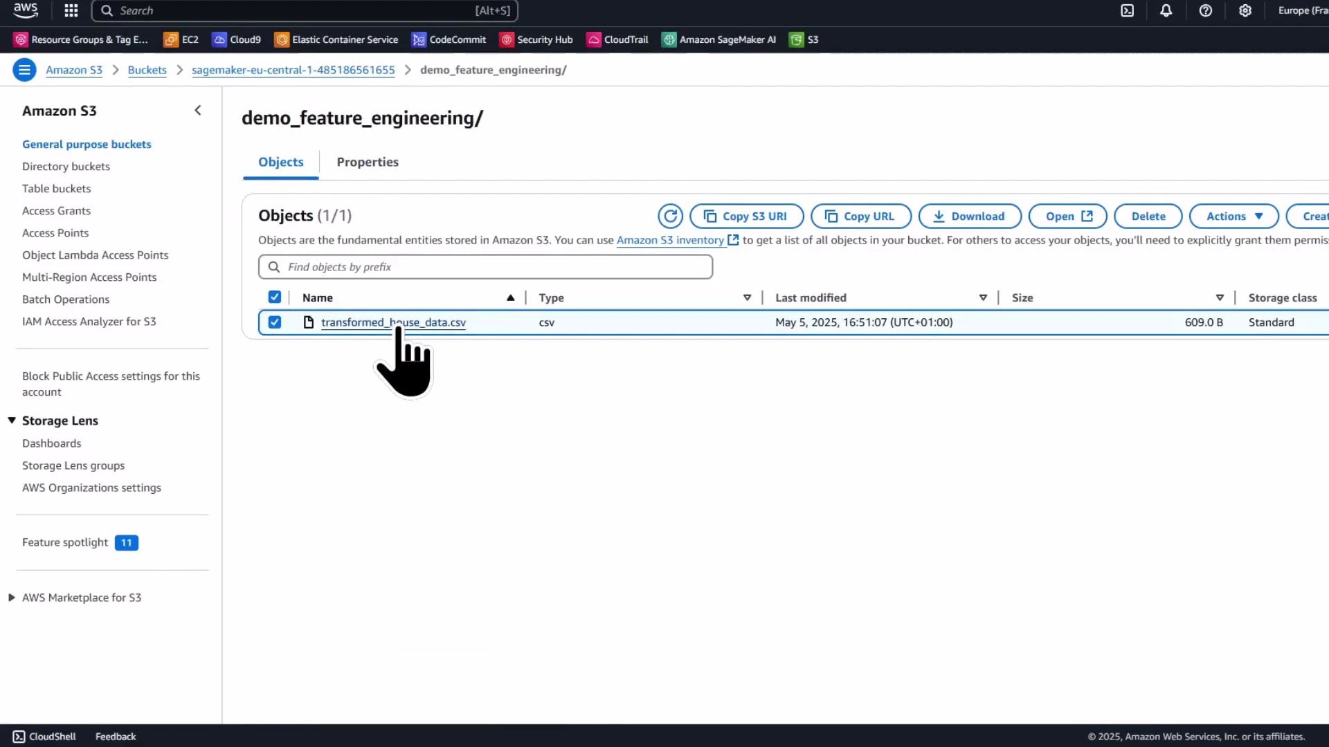 A screenshot of the Amazon S3 web console showing the "demo_feature_engineering" folder with a single selected object named "transformed_house_data.csv." The file entry (CSV, 609 B) is highlighted and toolbar actions like Download, Open, and Delete are visible.