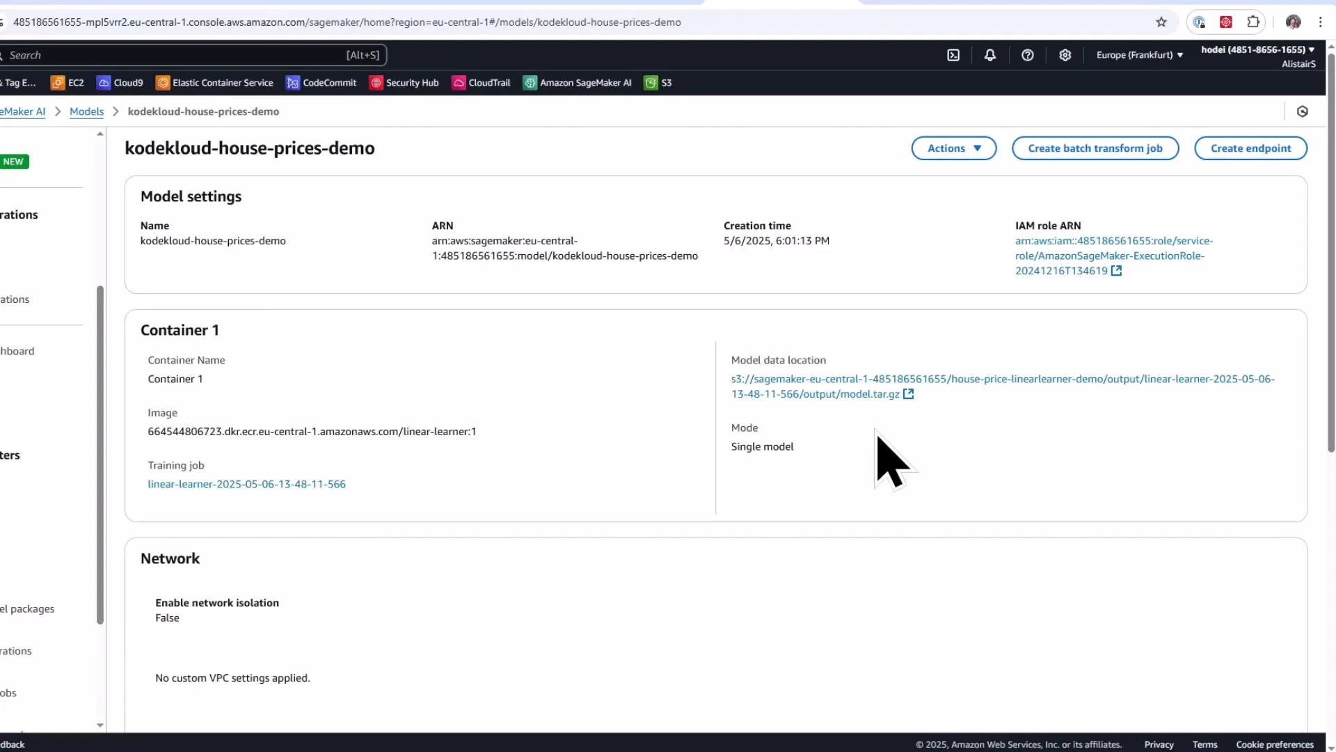 A screenshot of the Amazon SageMaker console showing a model page titled "kodekloud-house-prices-demo" with model settings, container details, S3 model data location, and network information. The page also shows action buttons (Create endpoint, Create batch transform job) and a large mouse cursor.