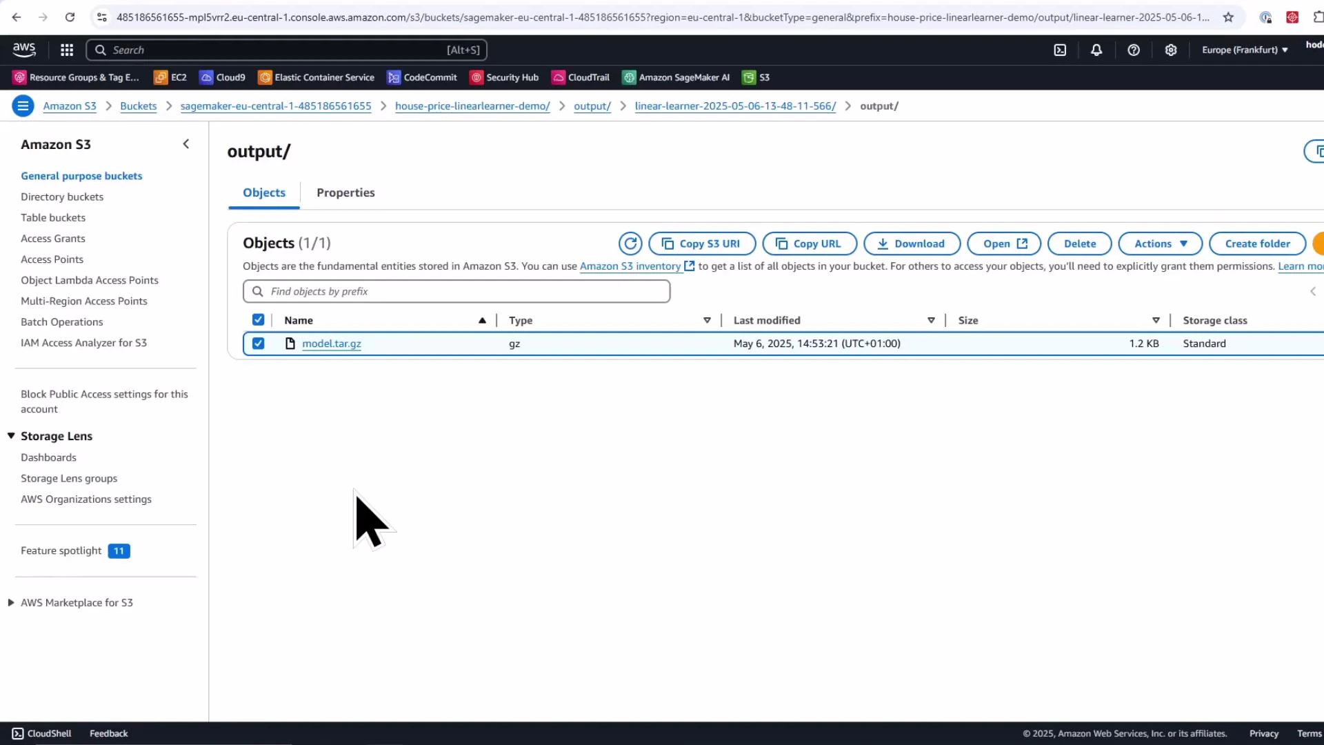 A screenshot of the Amazon S3 console showing the "output/" folder containing a single object named "model.tar.gz" (1.2 KB, last modified May 6, 2025). The UI shows S3 navigation on the left and action buttons (Copy S3 URI, Download, Open, Delete) across the top.