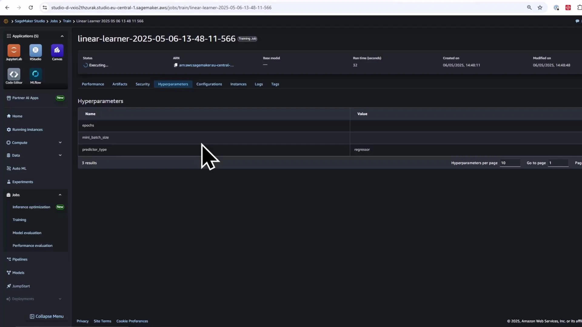 A screenshot of the Amazon SageMaker Studio web interface showing a running training job named "linear-learner-2025-05-06-13-48-11-566" with the Hyperparameters tab displayed. The table lists hyperparameter names like epochs, mini_batch_size and predictor_type (set to "regressor"), and a large cursor is visible.