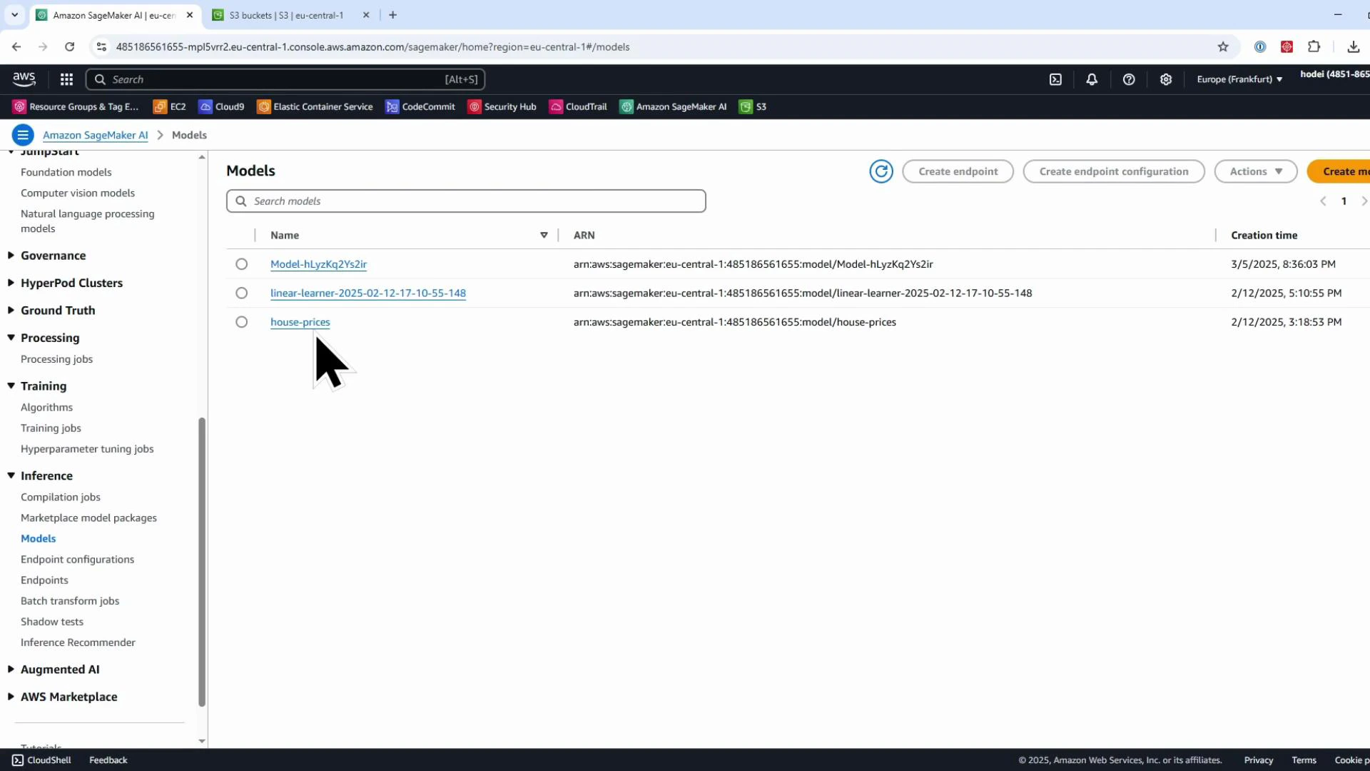 A browser screenshot of the Amazon SageMaker console showing the "Models" page with a list of model entries (e.g., Model-hLy..., linear-learner..., house-prices) and the left-hand navigation menu. A large pointer/cursor is hovering over the "house-prices" model.