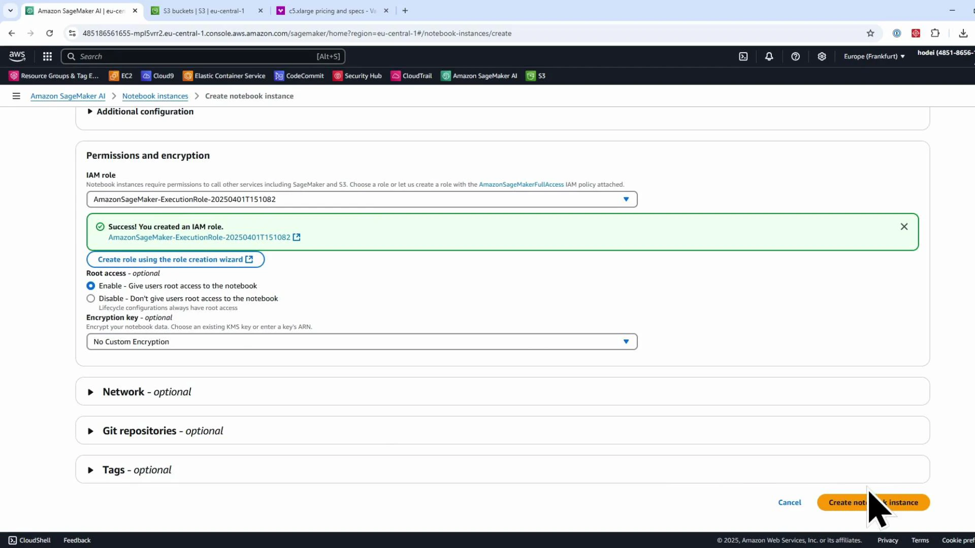 A screenshot of the AWS Management Console showing the Amazon SageMaker "Create notebook instance" page, focused on the Permissions and encryption section with a green success message about an IAM role. A large cursor is over the orange "Create notebook instance" button.