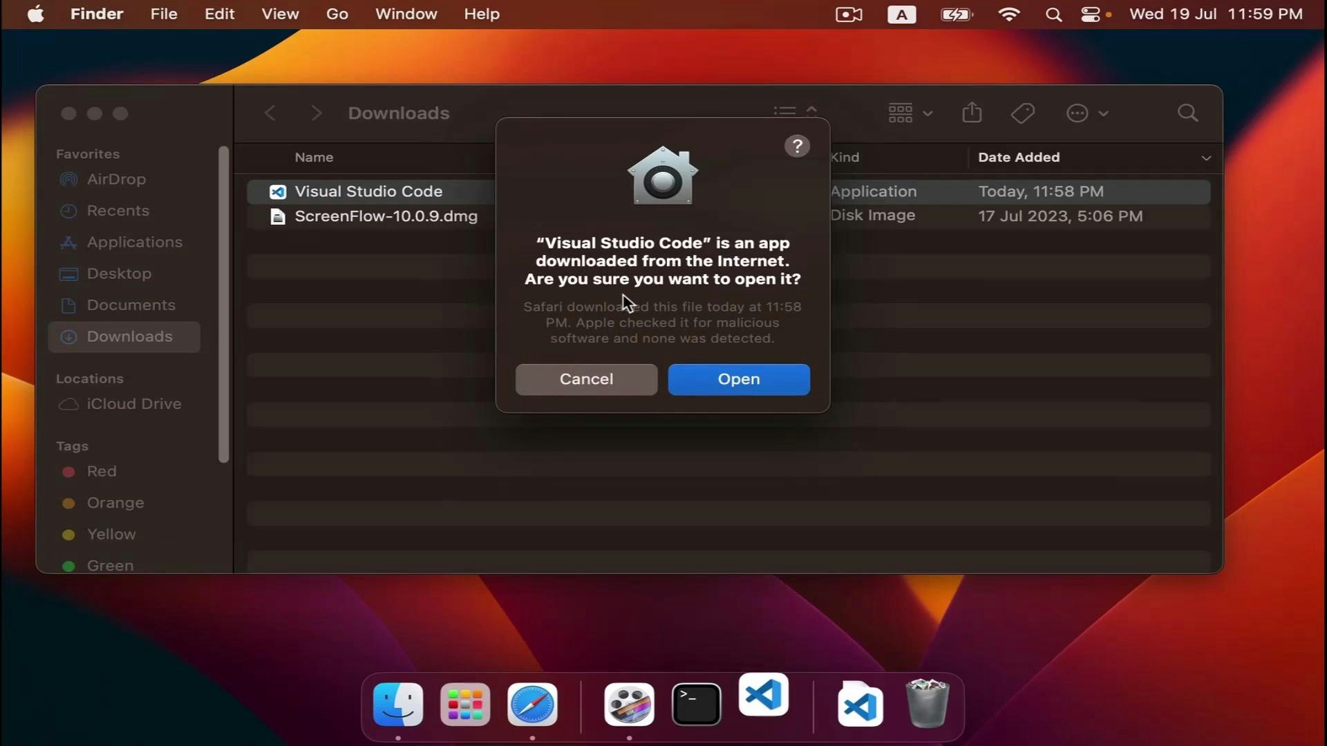 A macOS desktop screenshot showing the Finder Downloads folder with a security pop-up asking if you want to open "Visual Studio Code" (downloaded from the Internet) with Cancel and Open buttons. The Dock with app icons is visible along the bottom of the screen.