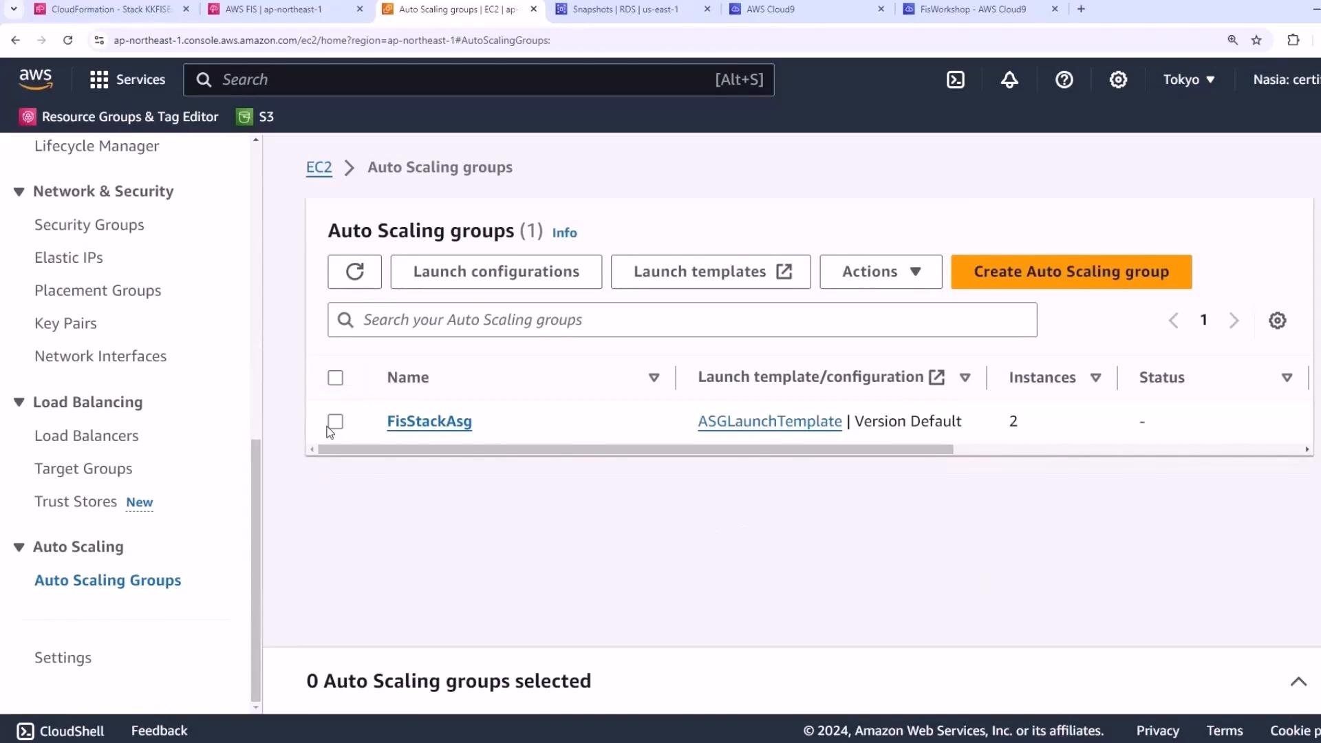 A screenshot of the AWS EC2 Auto Scaling Groups console. It shows one auto scaling group named "FisStackAsg" using the "ASGLaunchTemplate" launch template and a "Create Auto Scaling group" button.