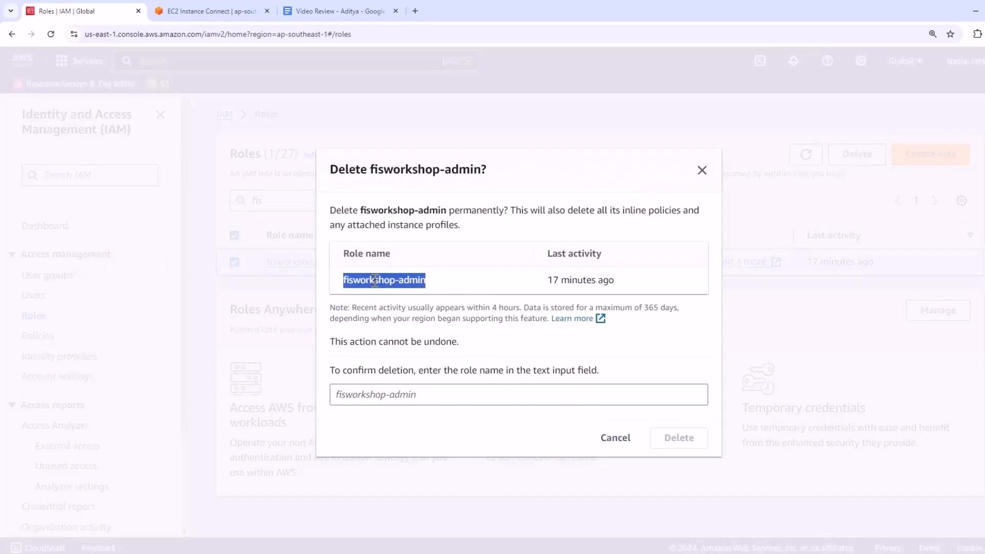 A screenshot of the AWS Identity and Access Management (IAM) console showing a confirmation dialog to delete the role "fisworkshop-admin." The modal shows the role's last activity (17 minutes ago) and prompts the user to type the role name to confirm deletion.