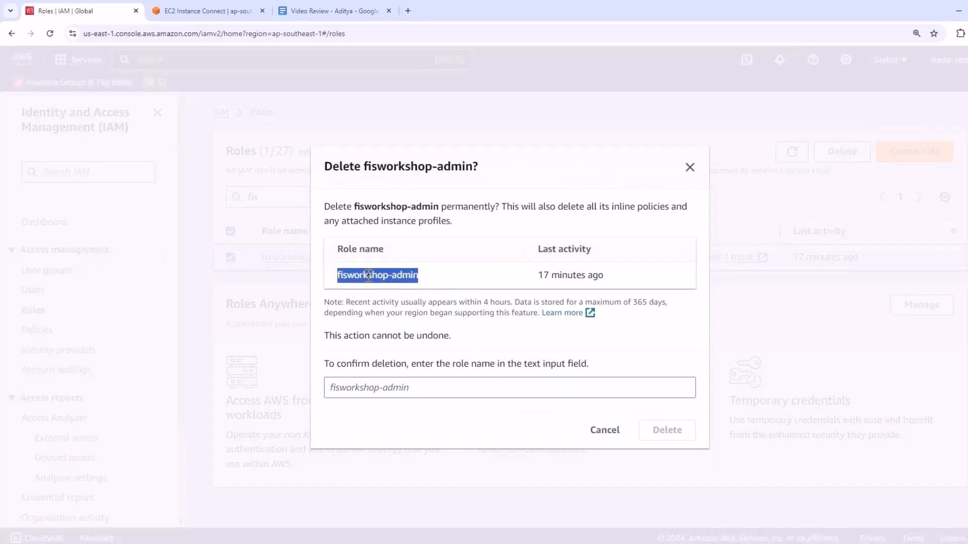 A screenshot of the AWS Identity and Access Management (IAM) console showing a confirmation dialog to delete the role "fisworkshop-admin." The modal shows the role's last activity (17 minutes ago) and prompts the user to type the role name to confirm deletion.