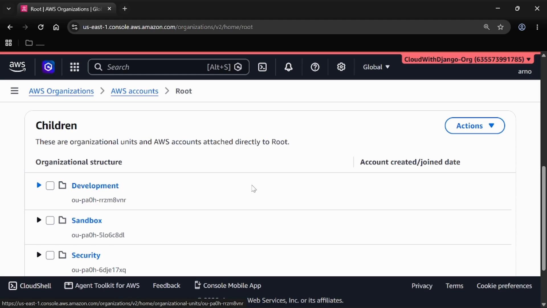 A screenshot of the AWS Organizations console showing the Root view with a "Children" list of organizational units (Development, Sandbox, Security) and an Actions menu. The browser header shows the CloudWithDjango-Org account.