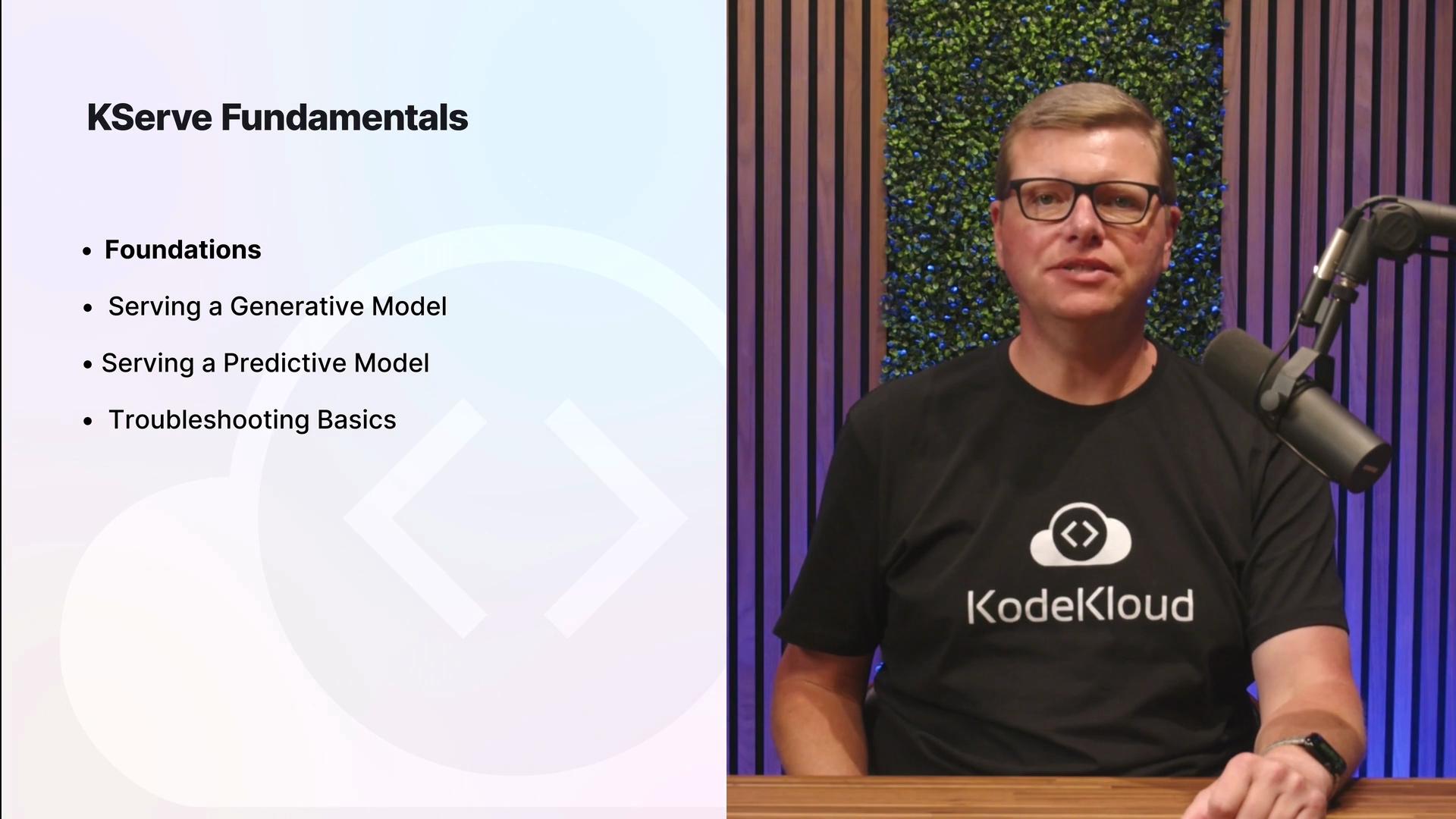 The image shows a man speaking into a microphone with a presentation slide titled "KServe Fundamentals" displaying a bulleted list of topics related to models and troubleshooting.