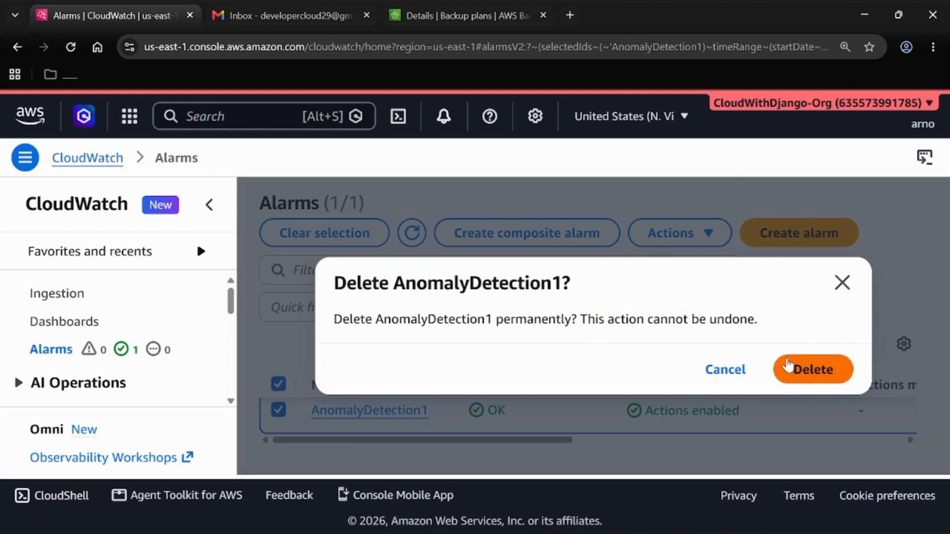 A screenshot of the AWS CloudWatch Alarms console with a confirmation dialog asking "Delete AnomalyDetection1?" to permanently delete the alarm. The dialog shows Cancel and a highlighted Delete button.