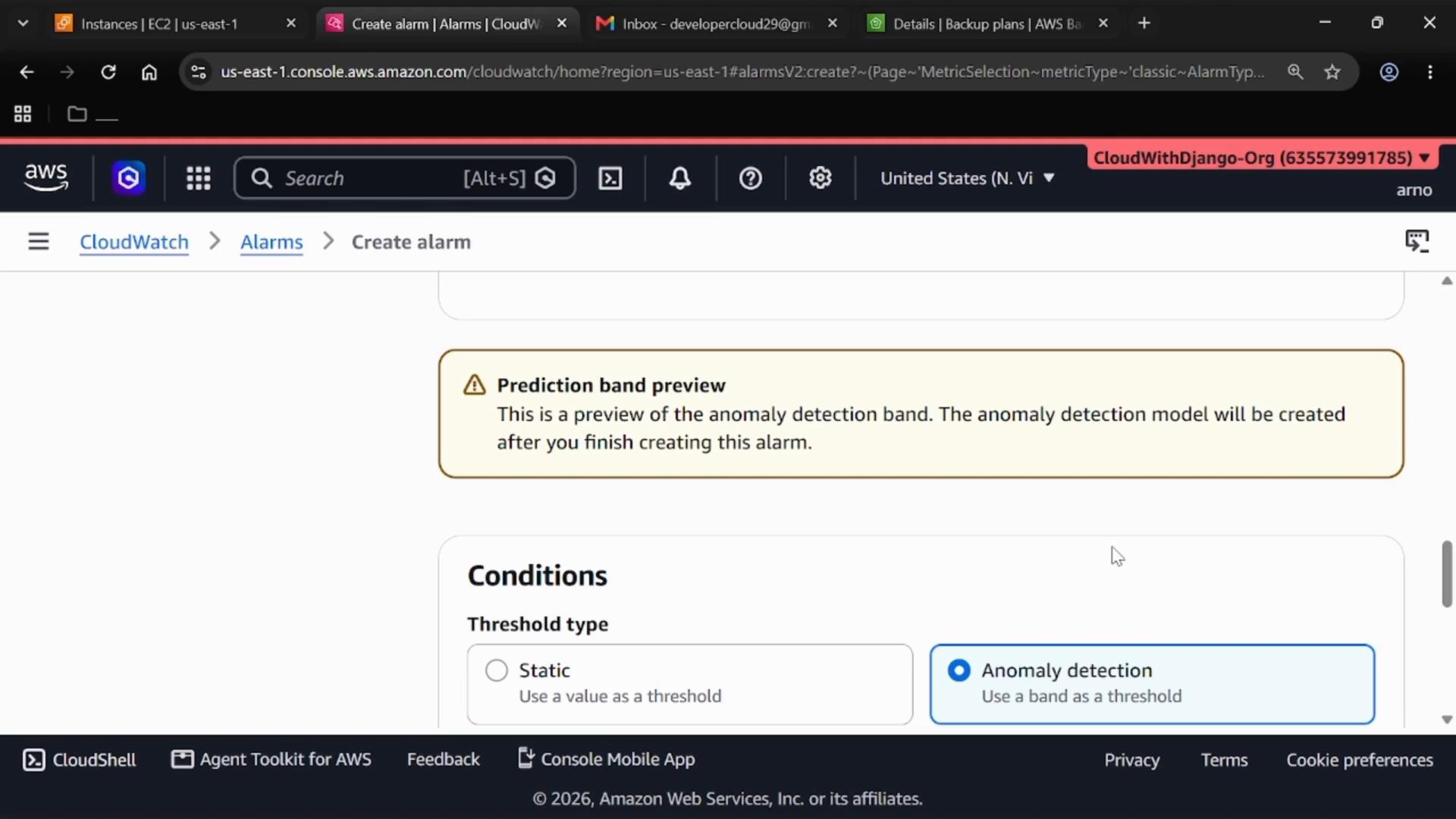A screenshot of the AWS CloudWatch "Create alarm" page showing a highlighted "Prediction band preview" warning about anomaly detection and a "Conditions" section with threshold options including Anomaly detection. The browser tab bar and AWS navigation header are visible at the top.
