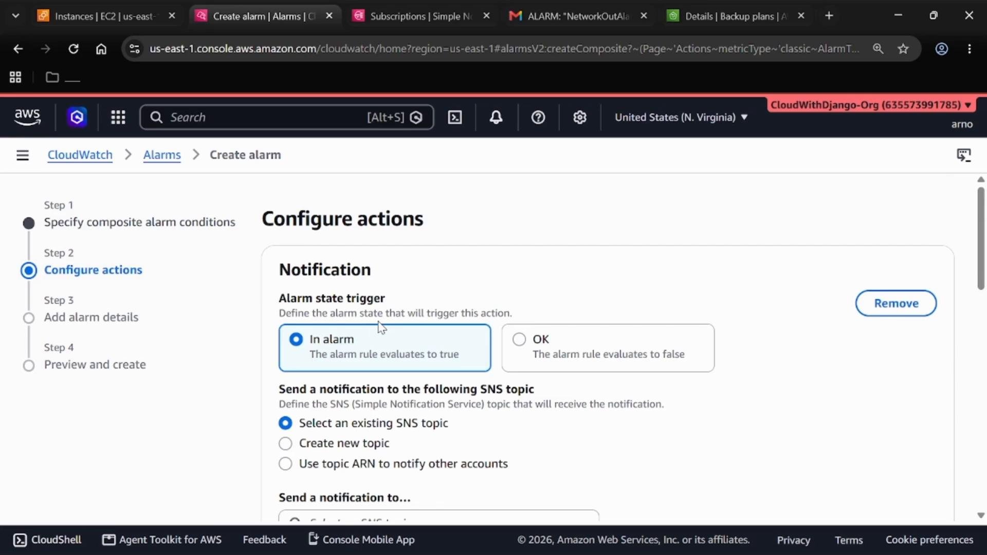 A screenshot of the AWS CloudWatch "Create alarm" page showing the "Configure actions" step. It displays notification settings with the "In alarm" trigger selected and options to choose an SNS topic.