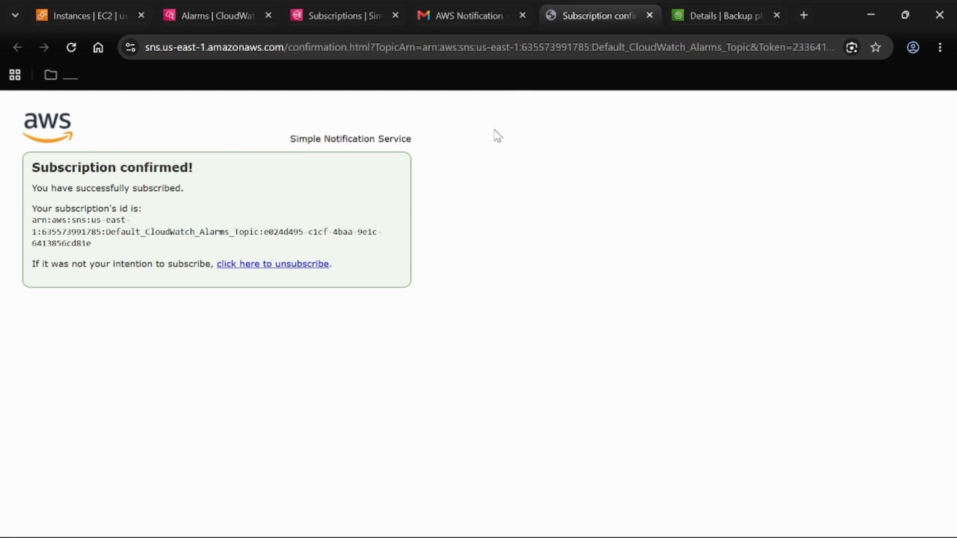 A web browser screenshot of an AWS Simple Notification Service page showing "Subscription confirmed!" with the subscription ARN and a link to unsubscribe. The page confirms successful subscription to a CloudWatch alarms topic.