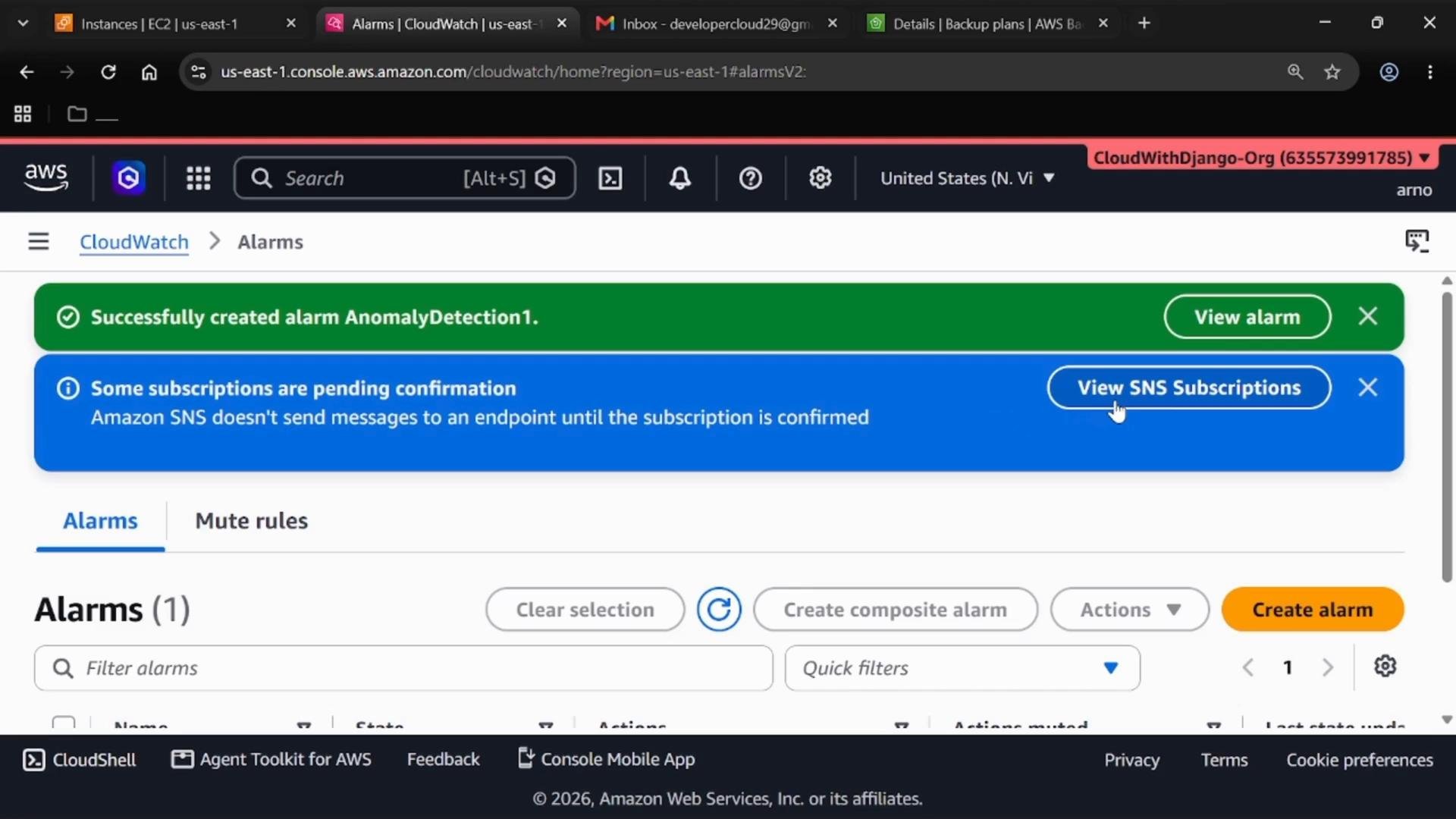 A screenshot of the AWS CloudWatch Alarms console showing a green confirmation banner saying "Successfully created alarm AnomalyDetection1." Below it is a blue info banner warning "Some subscriptions are pending confirmation" with a "View SNS Subscriptions" button and the Alarms list controls visible.