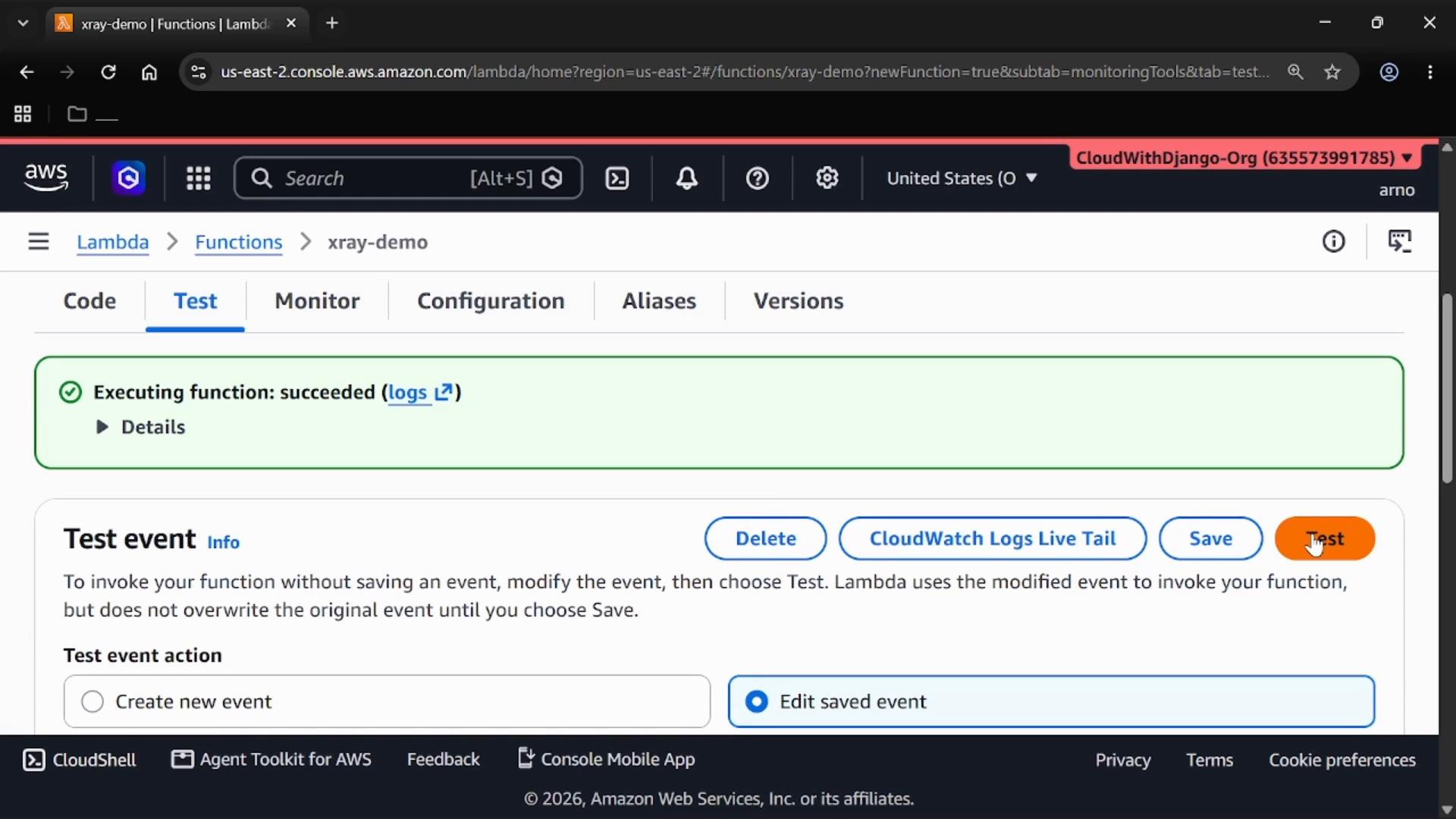 A screenshot of the AWS Lambda console on the "Test" tab showing a green banner that says "Executing function: succeeded" with links to logs. The lower part shows the "Test event" settings and a highlighted orange "Test" button.