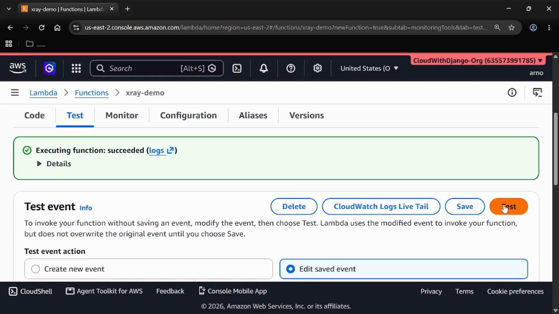 A screenshot of the AWS Lambda console on the "Test" tab showing a green banner that says "Executing function: succeeded" with links to logs. The lower part shows the "Test event" settings and a highlighted orange "Test" button.