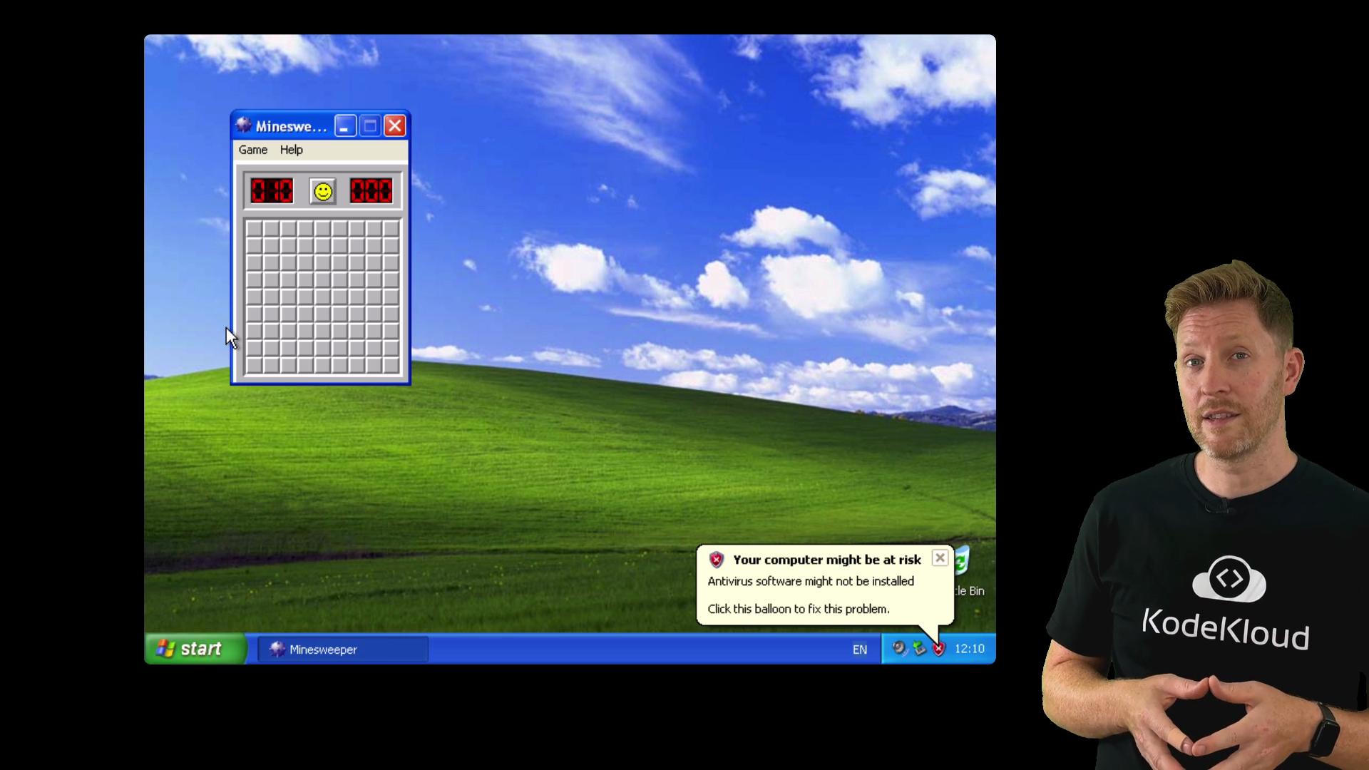 The image shows a screenshot of a Windows XP desktop with the Minesweeper game open and a security alert, alongside a person wearing a black KodeKloud t-shirt.