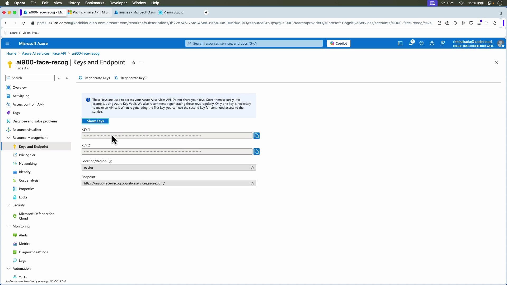A screenshot of the Microsoft Azure portal showing the "ai900-face-recog | Keys and Endpoint" page for the Face API, with masked keys, Location/Region set to "eastus," and the service endpoint URL displayed. The Azure left-hand navigation menu and top browser tabs are also visible.