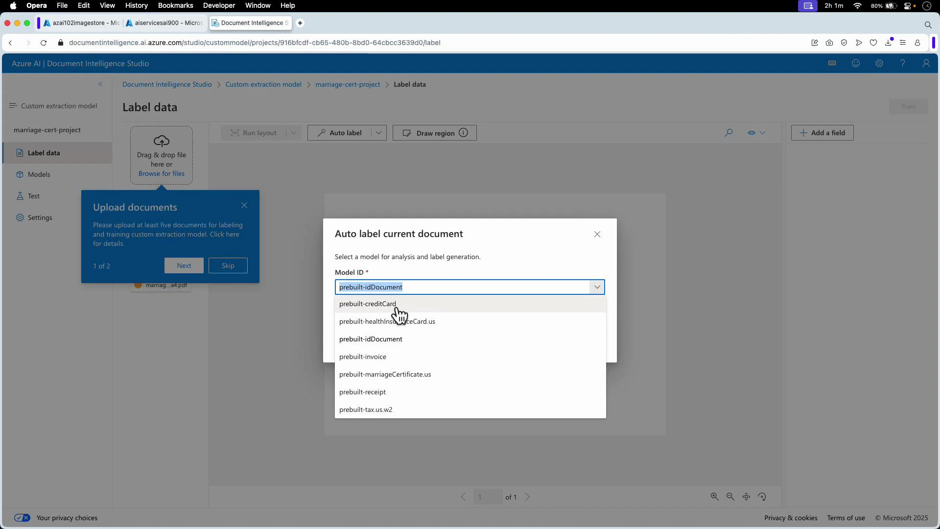 A screenshot of Azure AI Document Intelligence Studio with an "Auto label current document" dialog open, showing a dropdown list of prebuilt model IDs (e.g., prebuilt-idDocument, prebuilt-creditCard, prebuilt-invoice). A blue "Upload documents" pop-up on the left prompts the user to upload at least five documents for labeling.